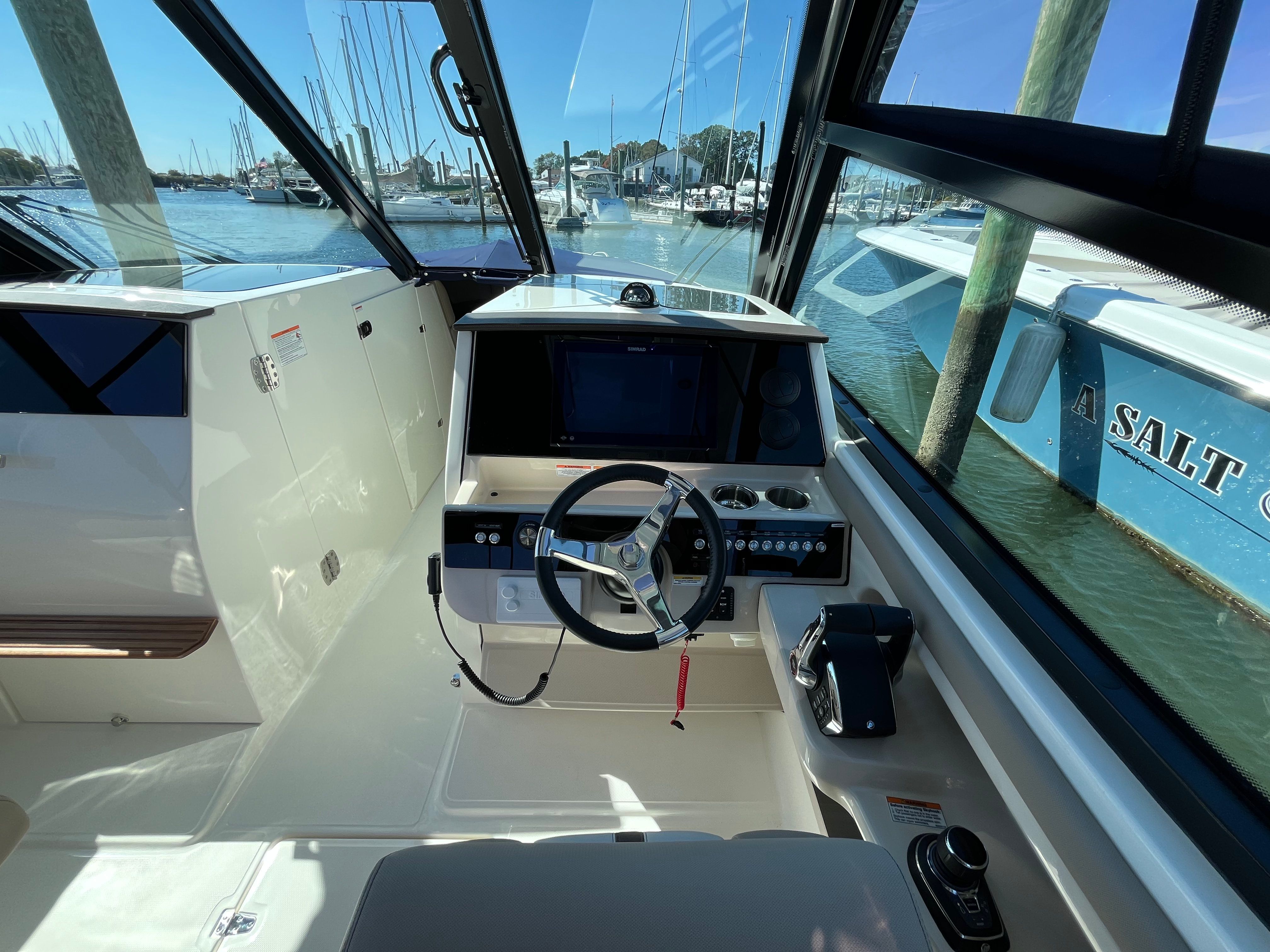 The cockpit of a Boston Whaler 330 Vantage with modern steering and instruments.