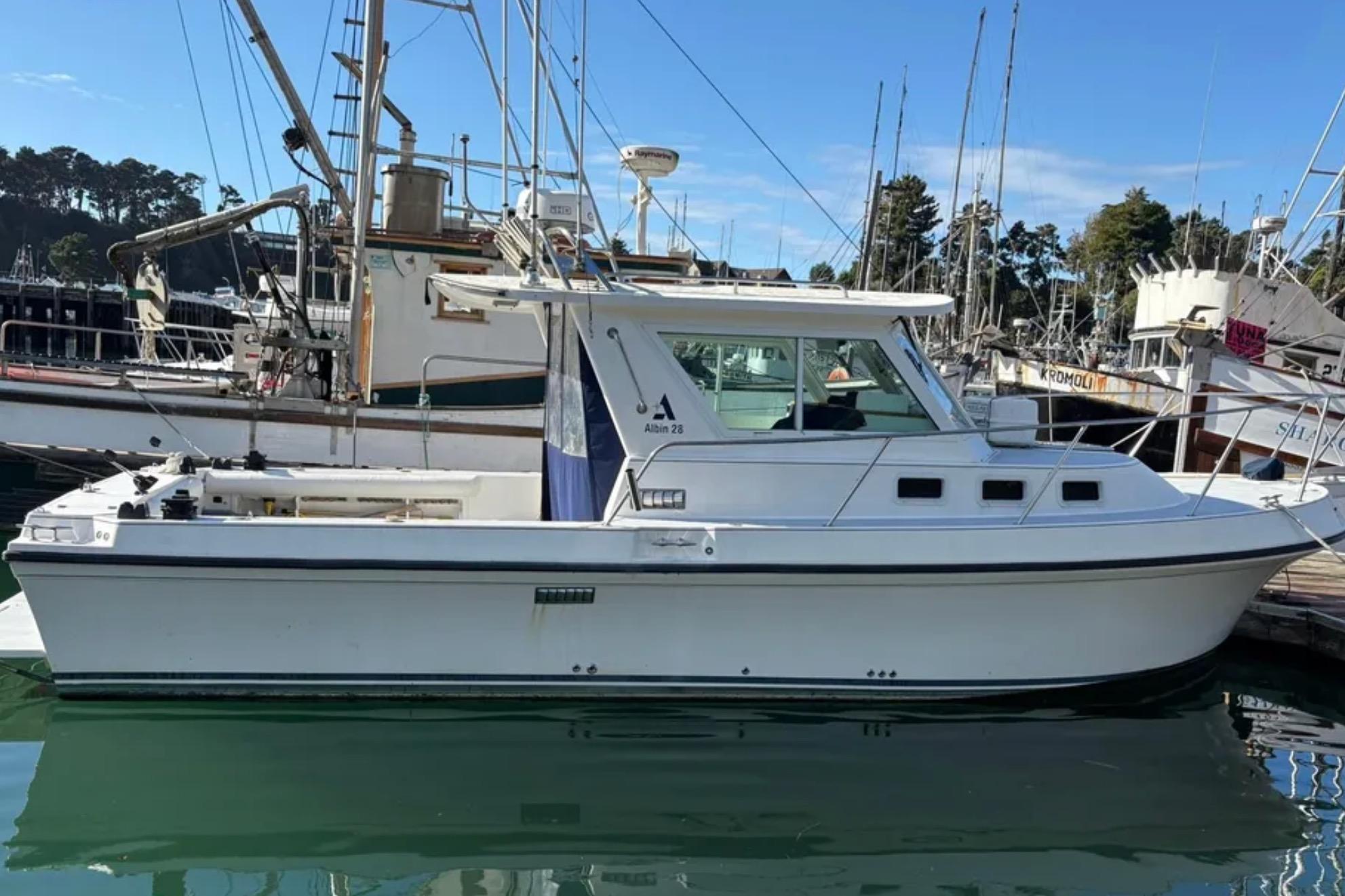 2005 Albin 28 Tournament Express boat docked in a marina, side view.