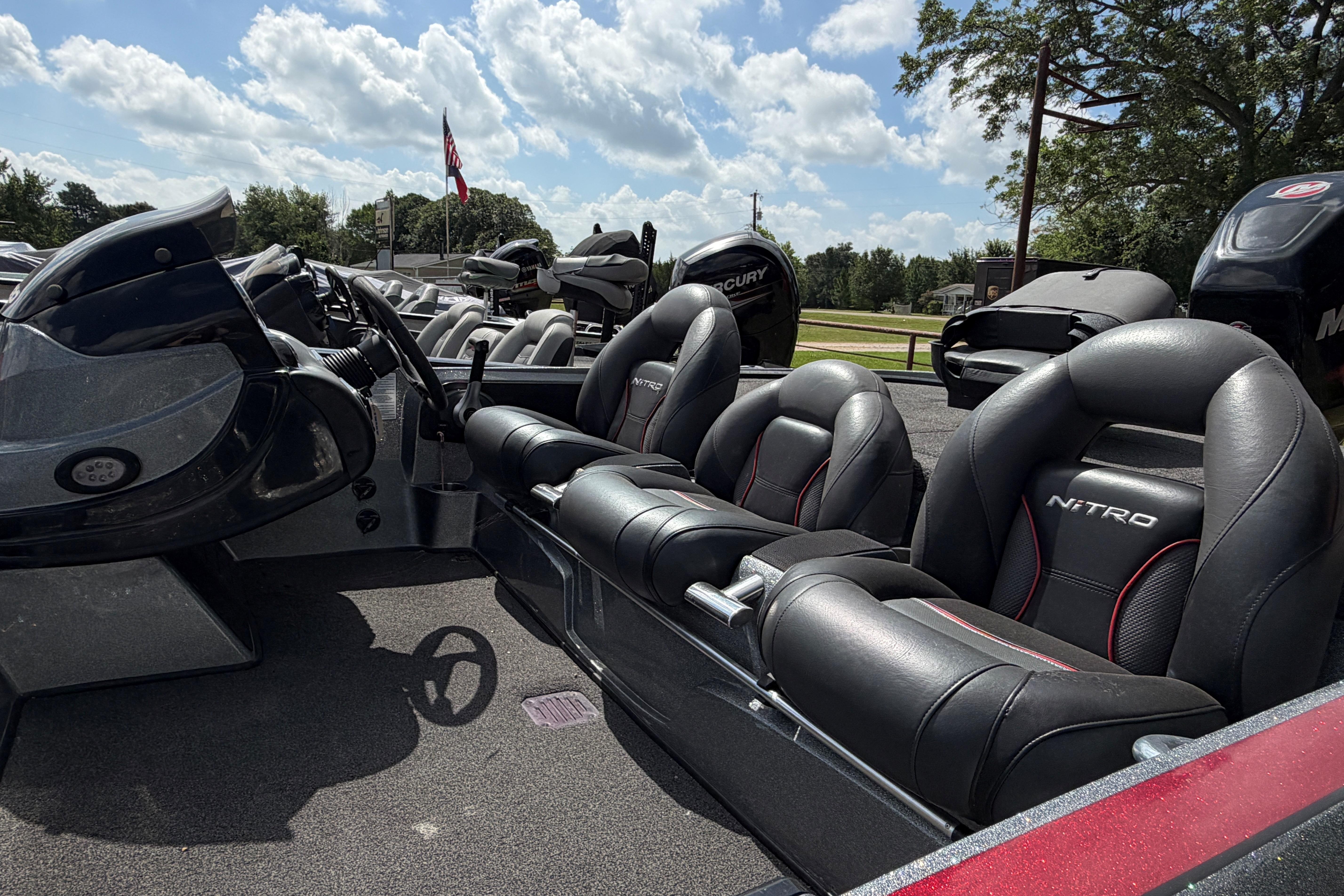 2015 Nitro Z-8 boat interior with black leather seats under a sunny sky.