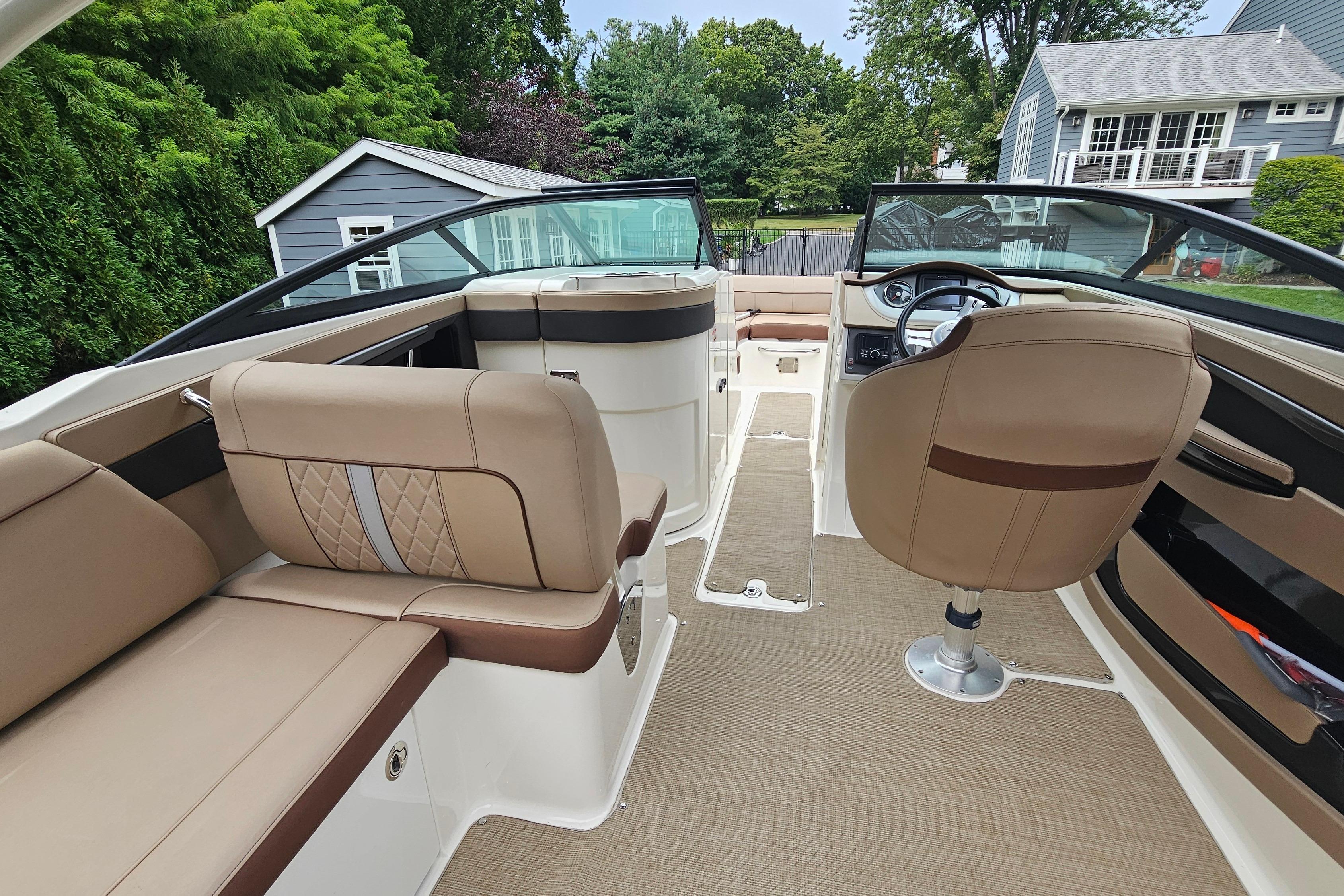 2017 Sea Ray SDX 240 Outboard interior with beige seating and modern dashboard.
