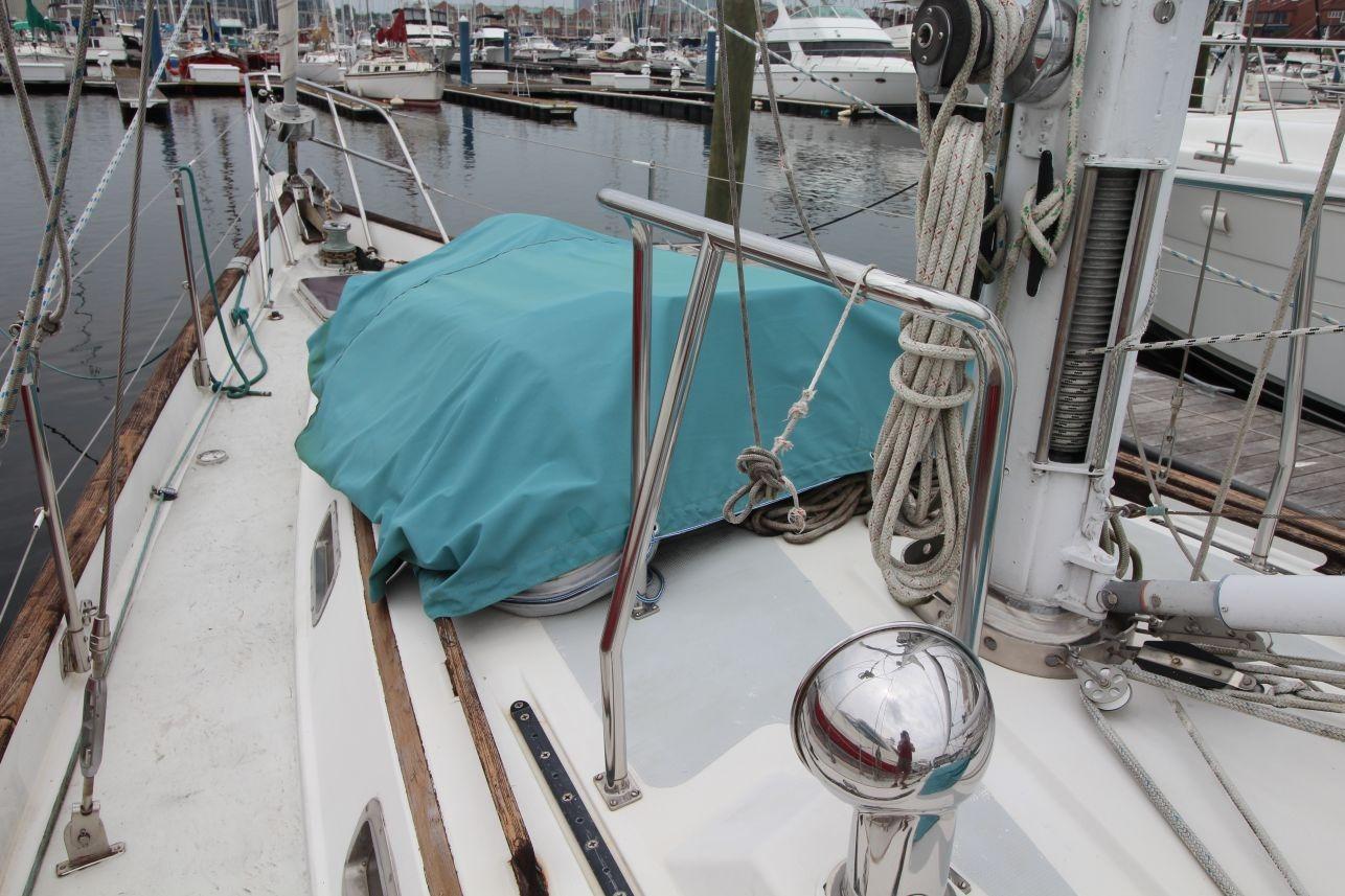 Sailboat deck view, Passport 47 model, 1985, docked in marina.