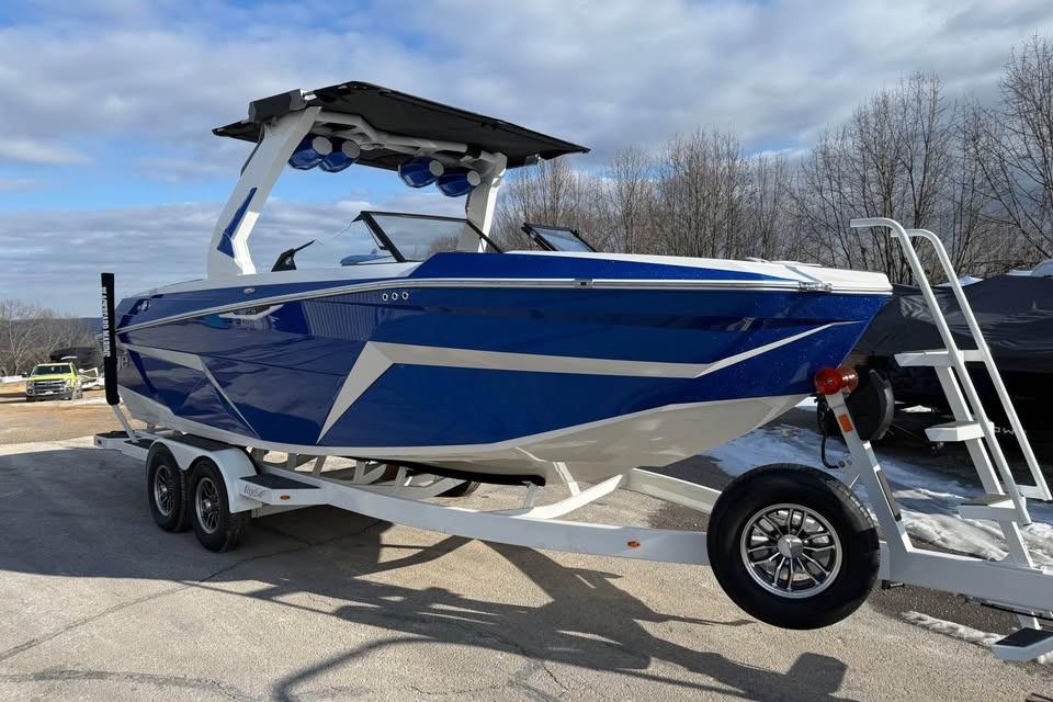 2026 Tigé Z3 boat in blue on a trailer, parked outdoors.