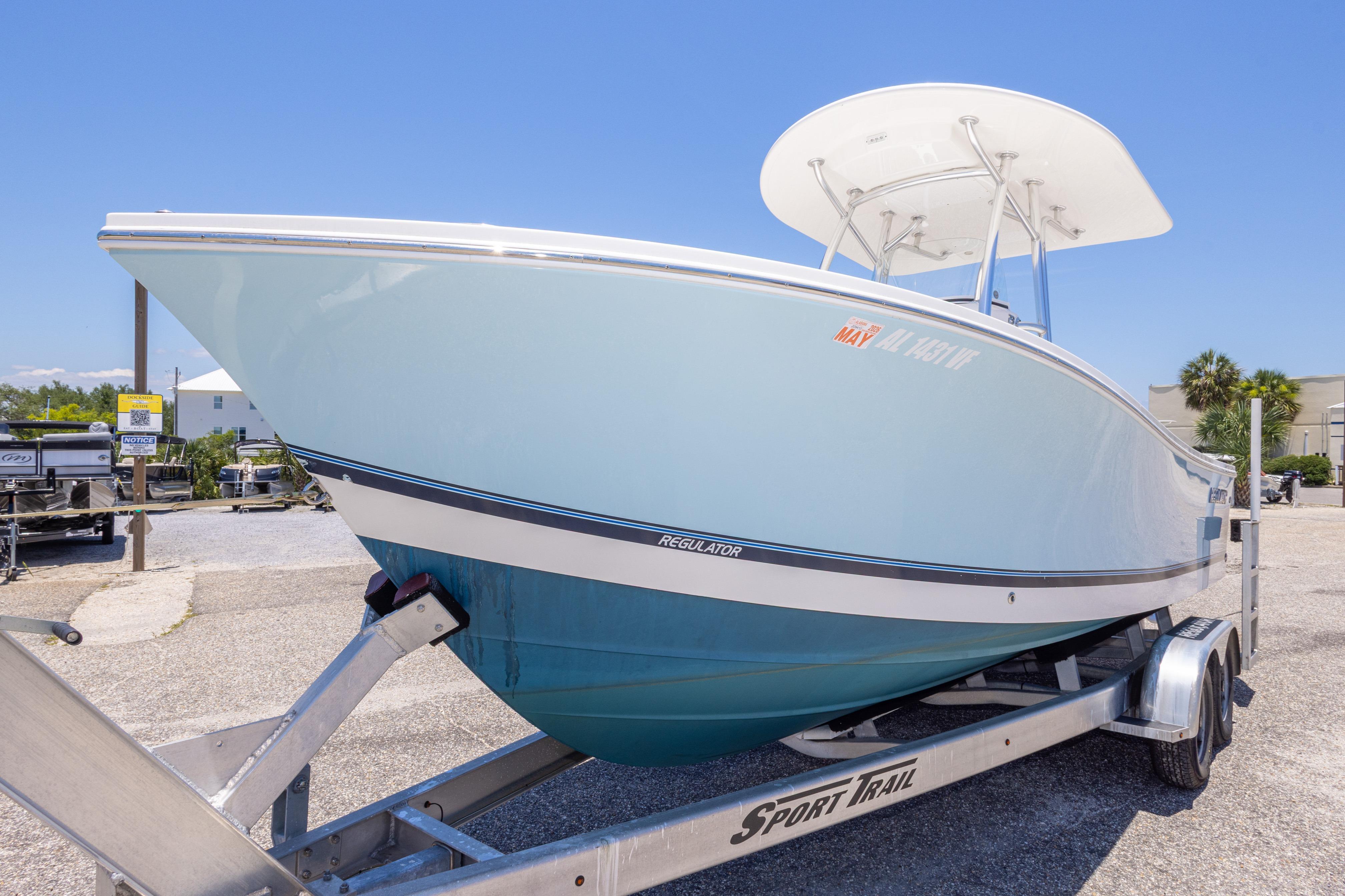 2019 Regulator 23 Center Console boat on trailer, displayed outdoors under clear blue sky.