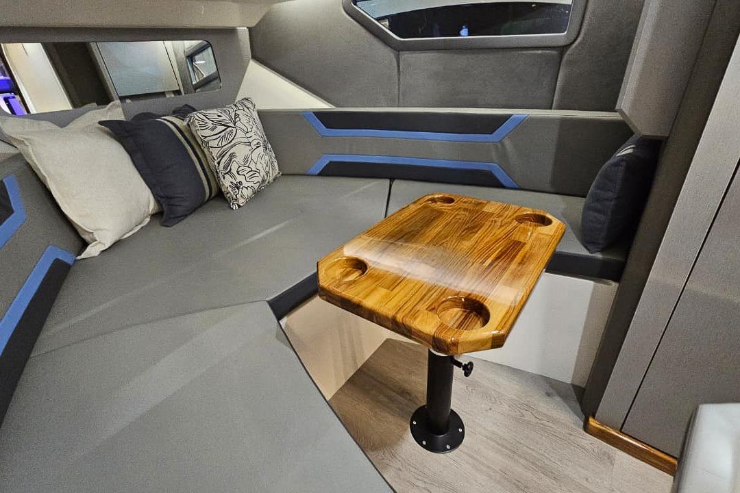 Modern interior of Hanover 327, 2026 model, featuring sleek seating and wooden table.