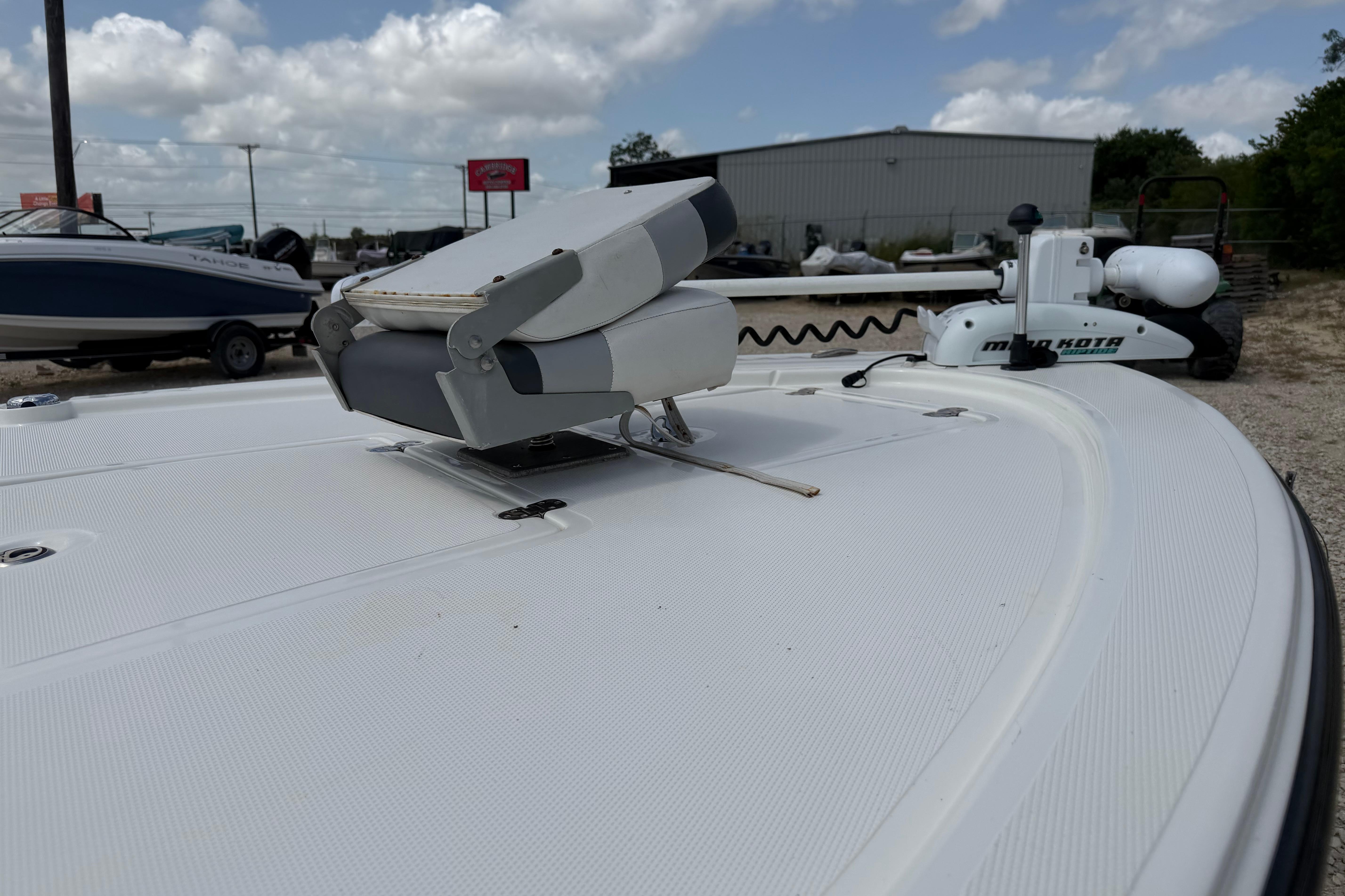 2012 Mako 18 LTS boat deck with Minn Kota trolling motor under cloudy sky.