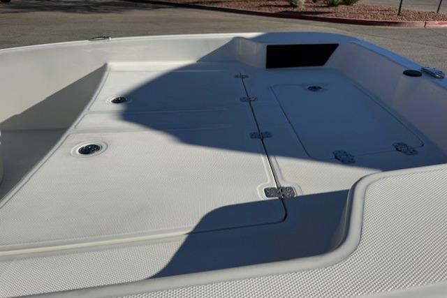 2026 Mako Pro Skiff 15 CC boat deck with storage compartments and textured surface.