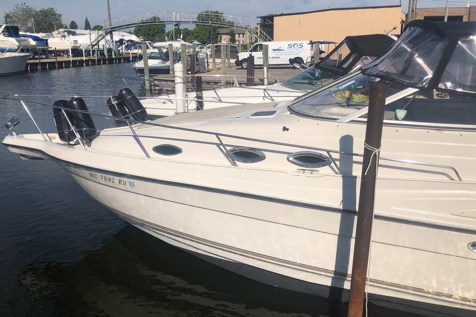 1999 Regal Commodore 2760 boat docked at marina, sunny day.
