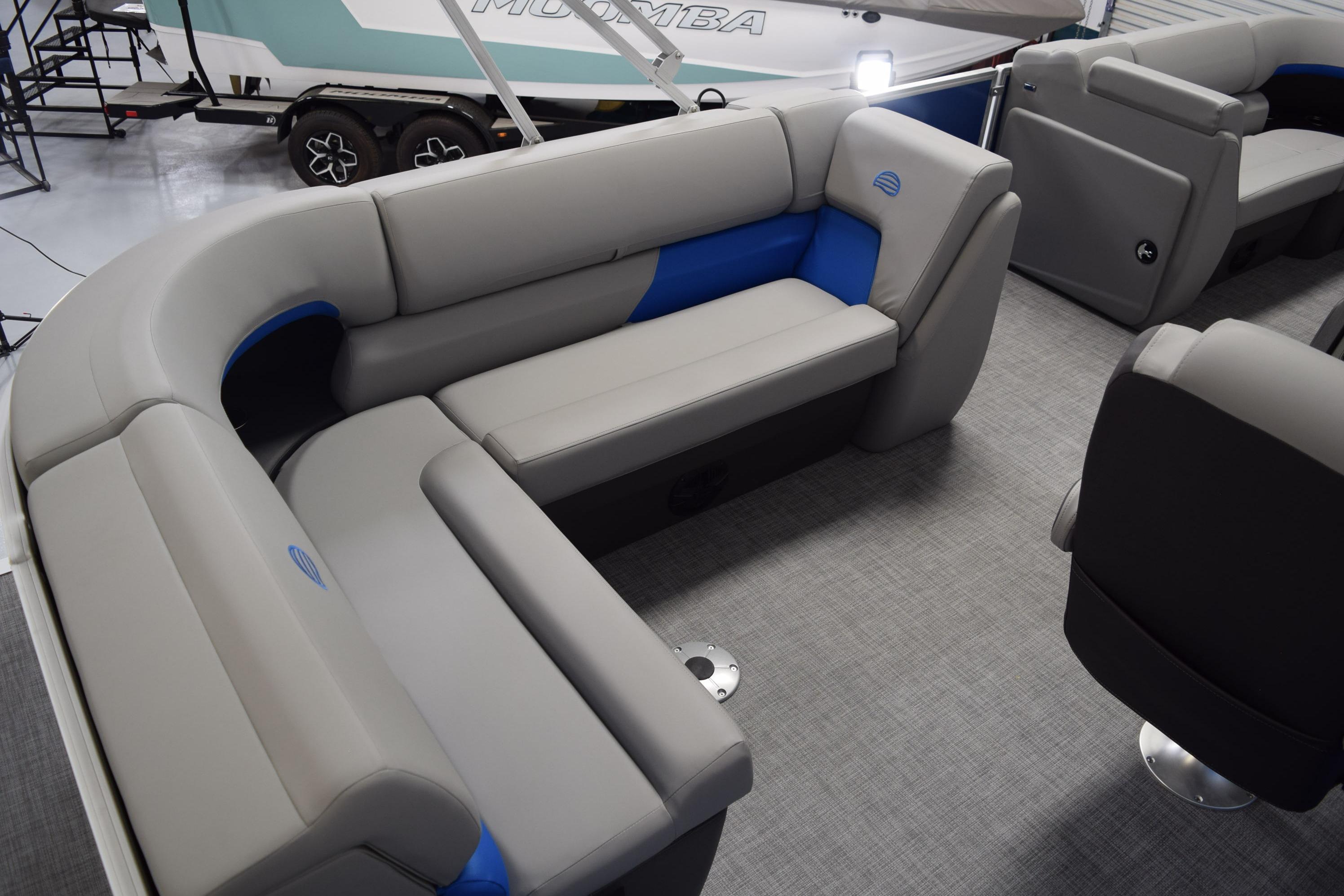 2026 Sun Tracker Party Barge 20 DLX interior with gray and blue seating.