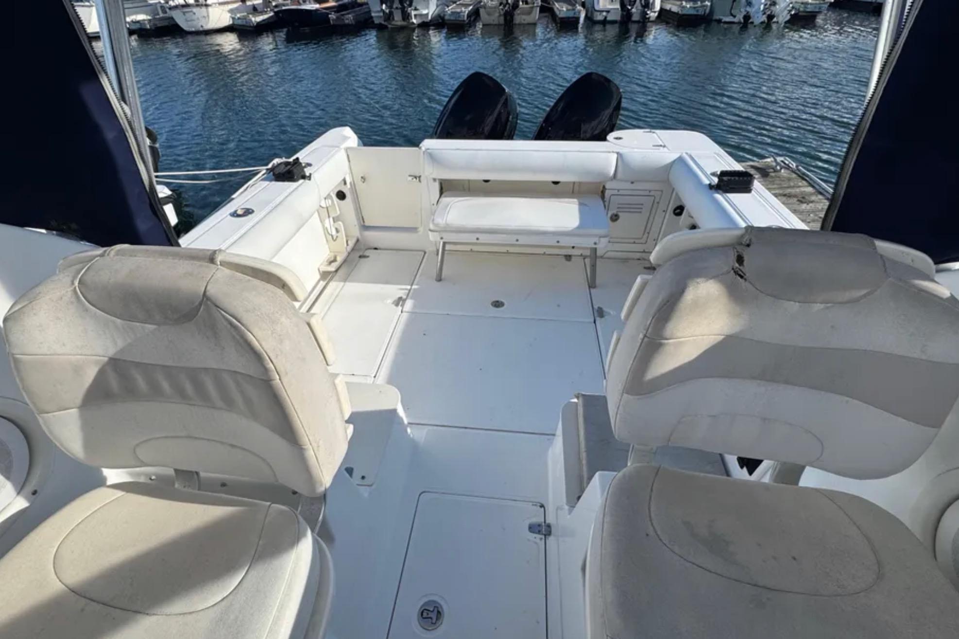 2004 Boston Whaler 255 Conquest boat interior with seating, docked at marina.