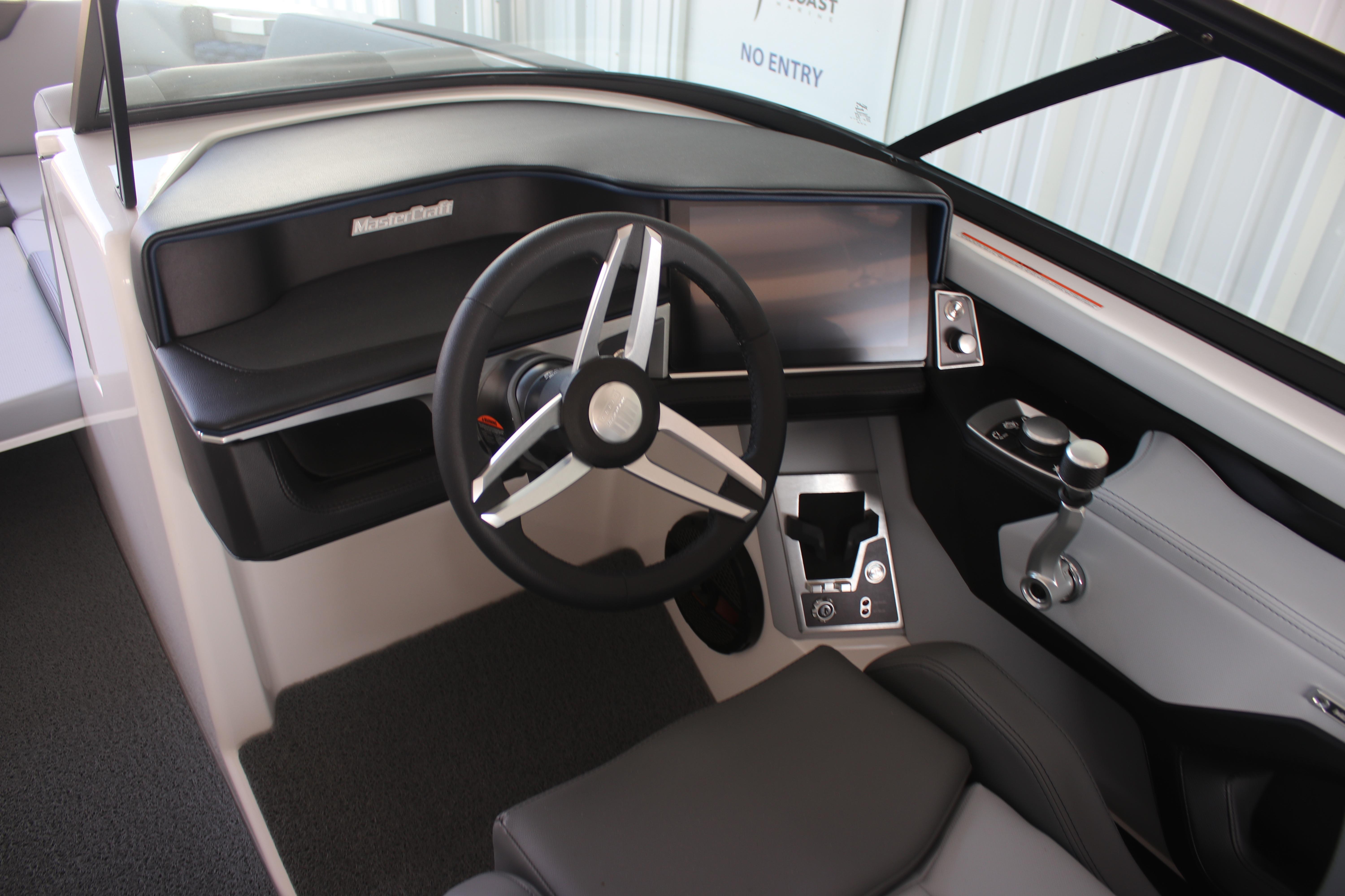2025 MasterCraft XT22 boat dashboard with modern steering wheel and controls.