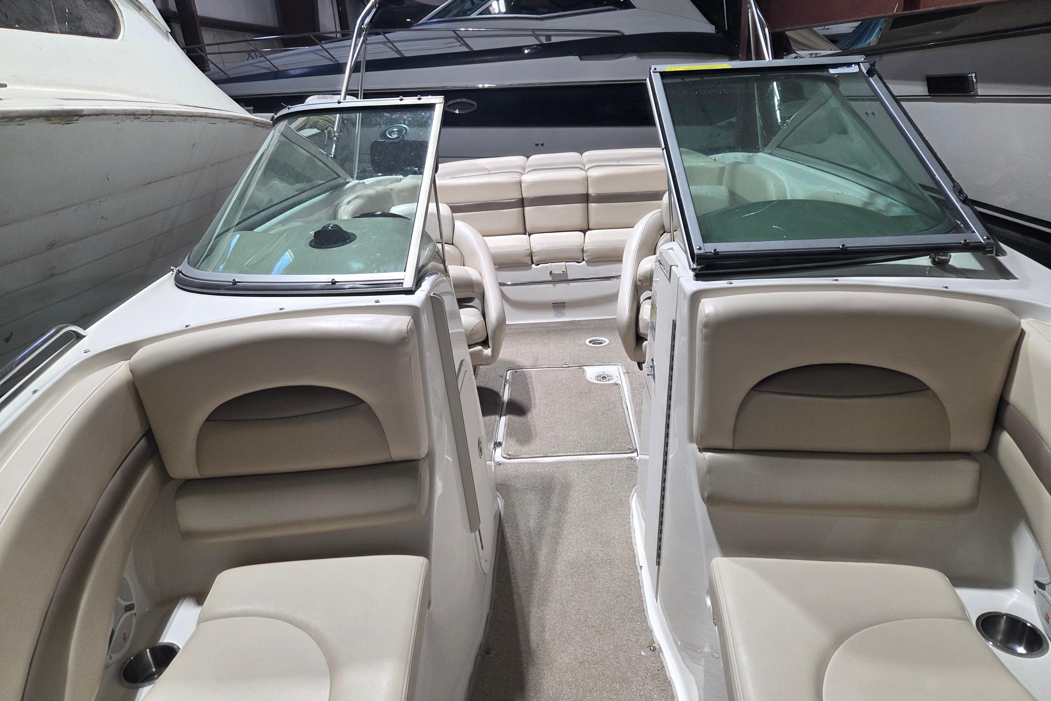 2006 Chaparral 236 SSi boat interior with beige seating and dual windshields.