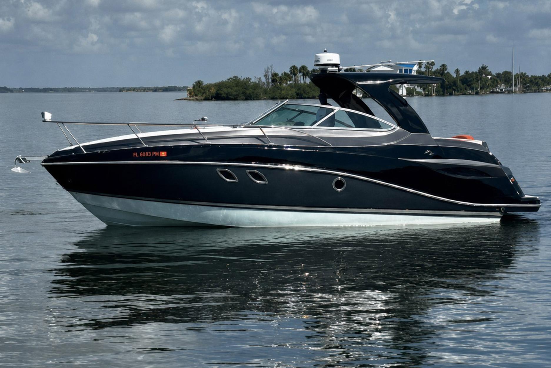 2012 Rinker 310 Express Cruiser LE on calm water, sleek design, and modern features.