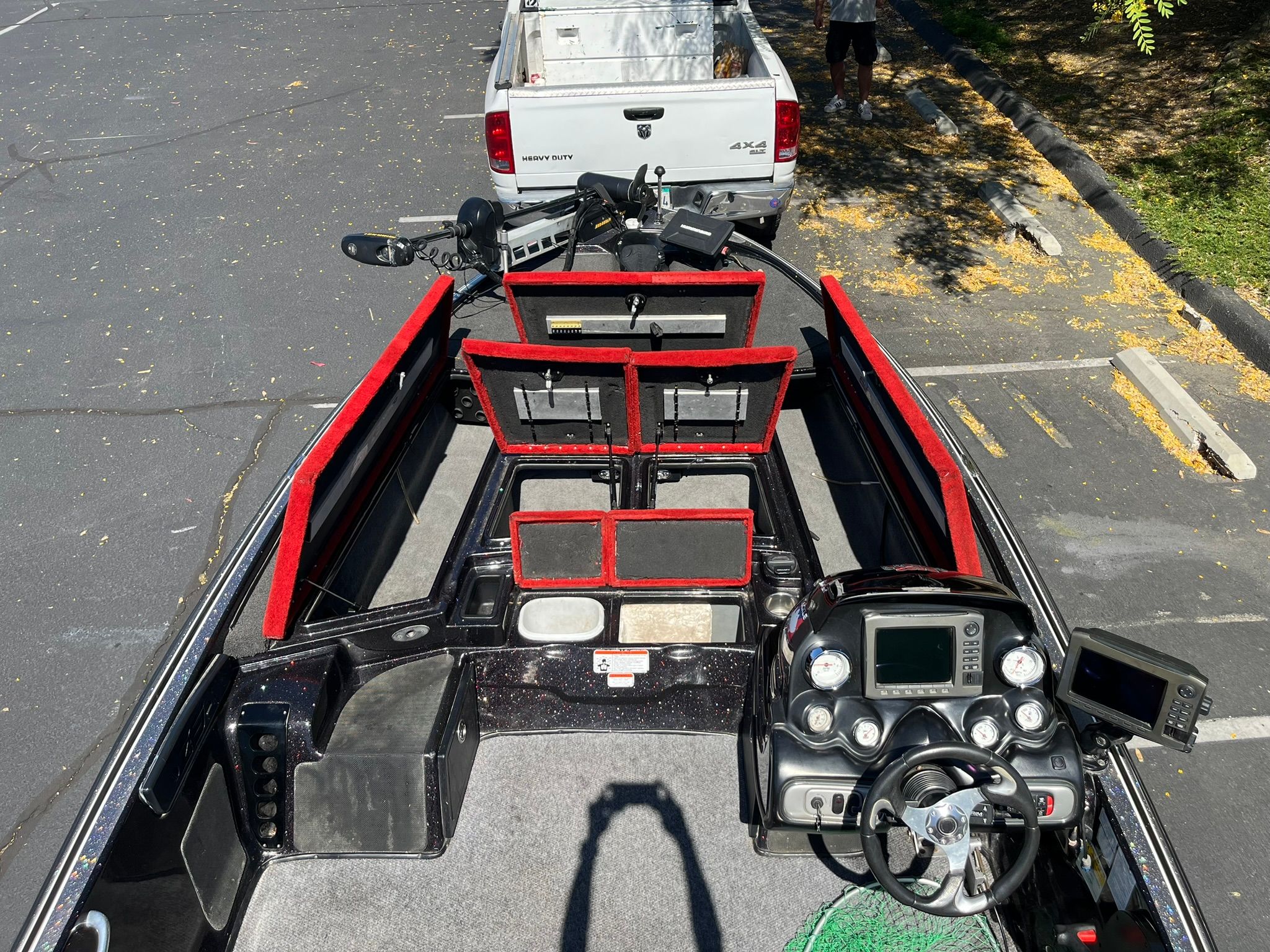 2013 Nitro Z-9 boat in parking area with open compartments.
