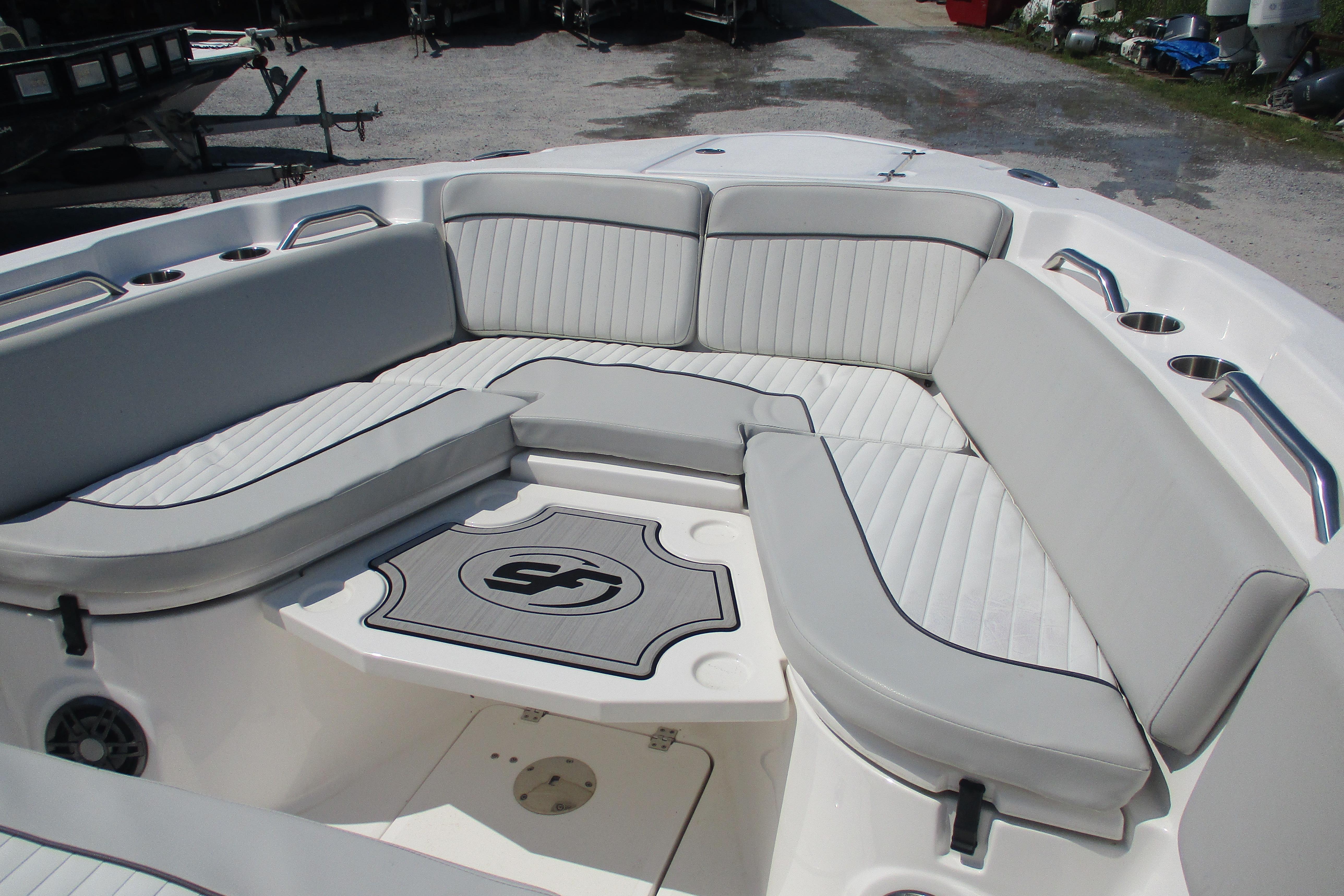 2024 Sea Fox 268 Commander boat interior with cushioned seating and cup holders.