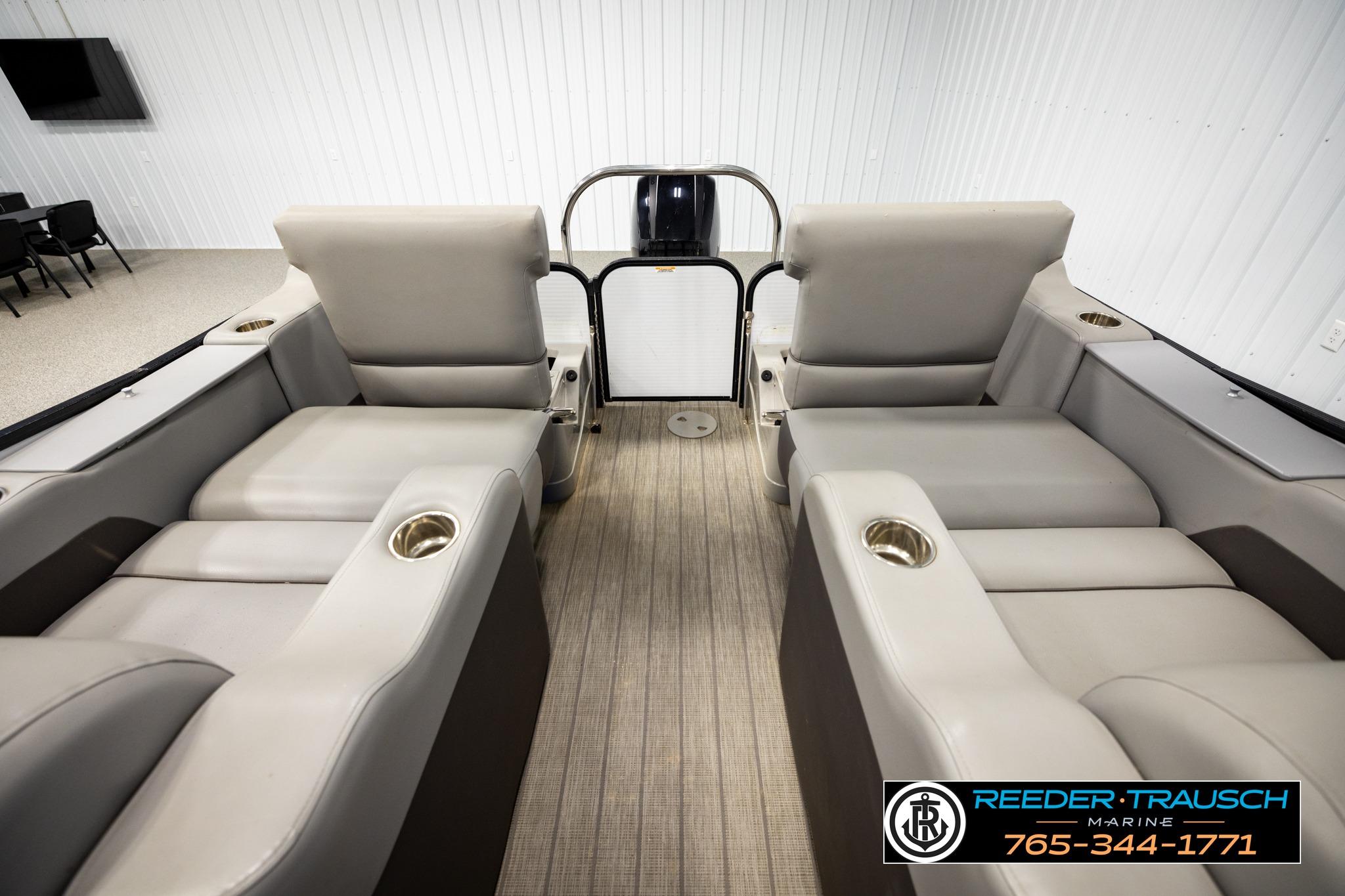2019 Manitou Oasis SR VP pontoon boat interior with plush seating and cup holders.