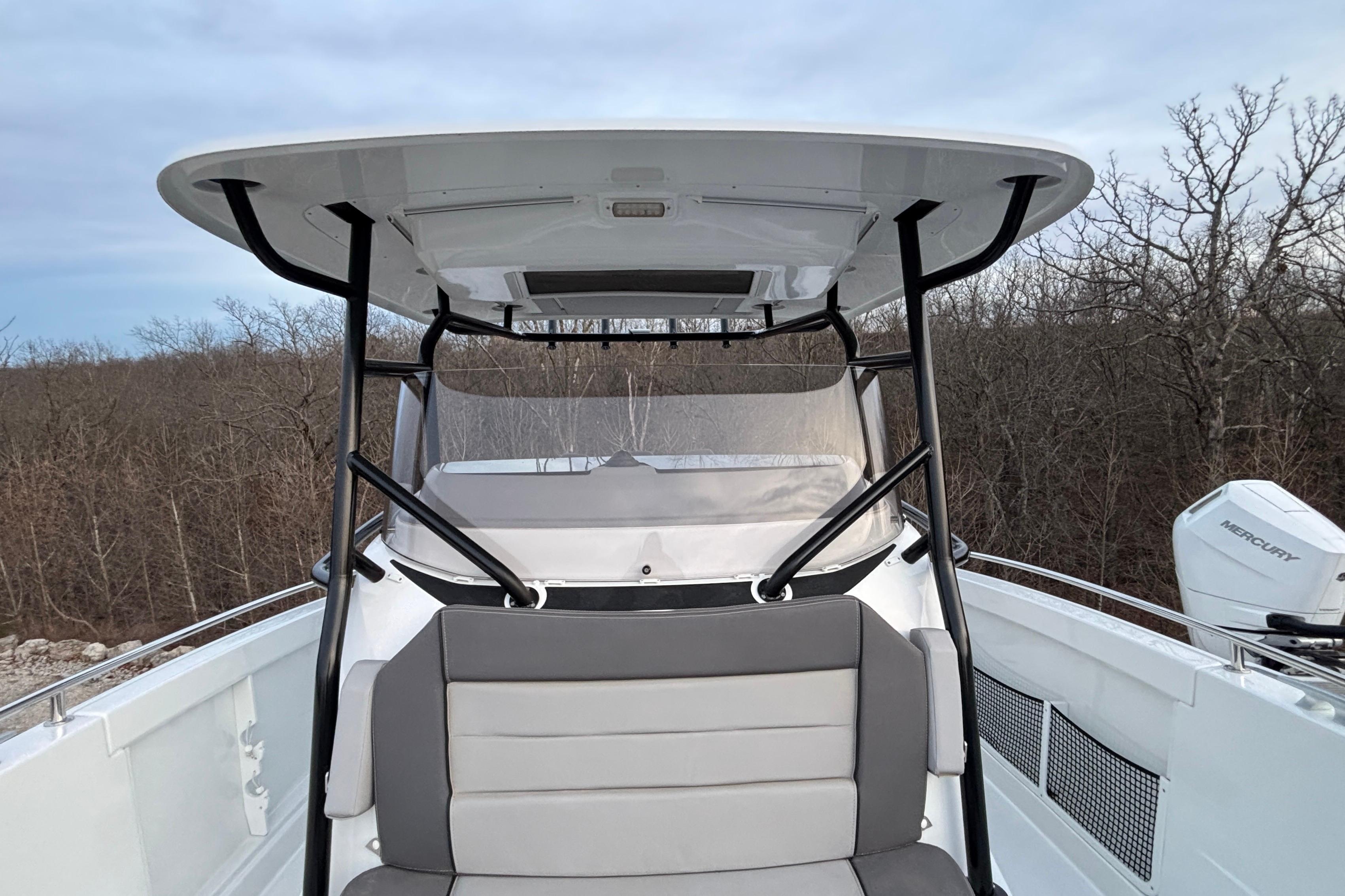2022 Jeanneau Leader 9.0 CC boat with seating and canopy, outdoors.
