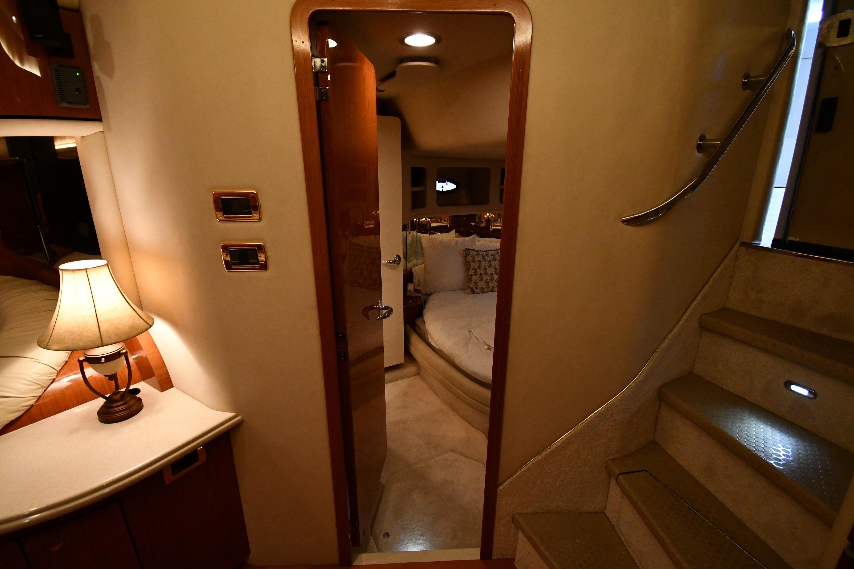 Interior of 2001 Sea Ray 540 Sundancer yacht, featuring cozy cabin and elegant lighting.