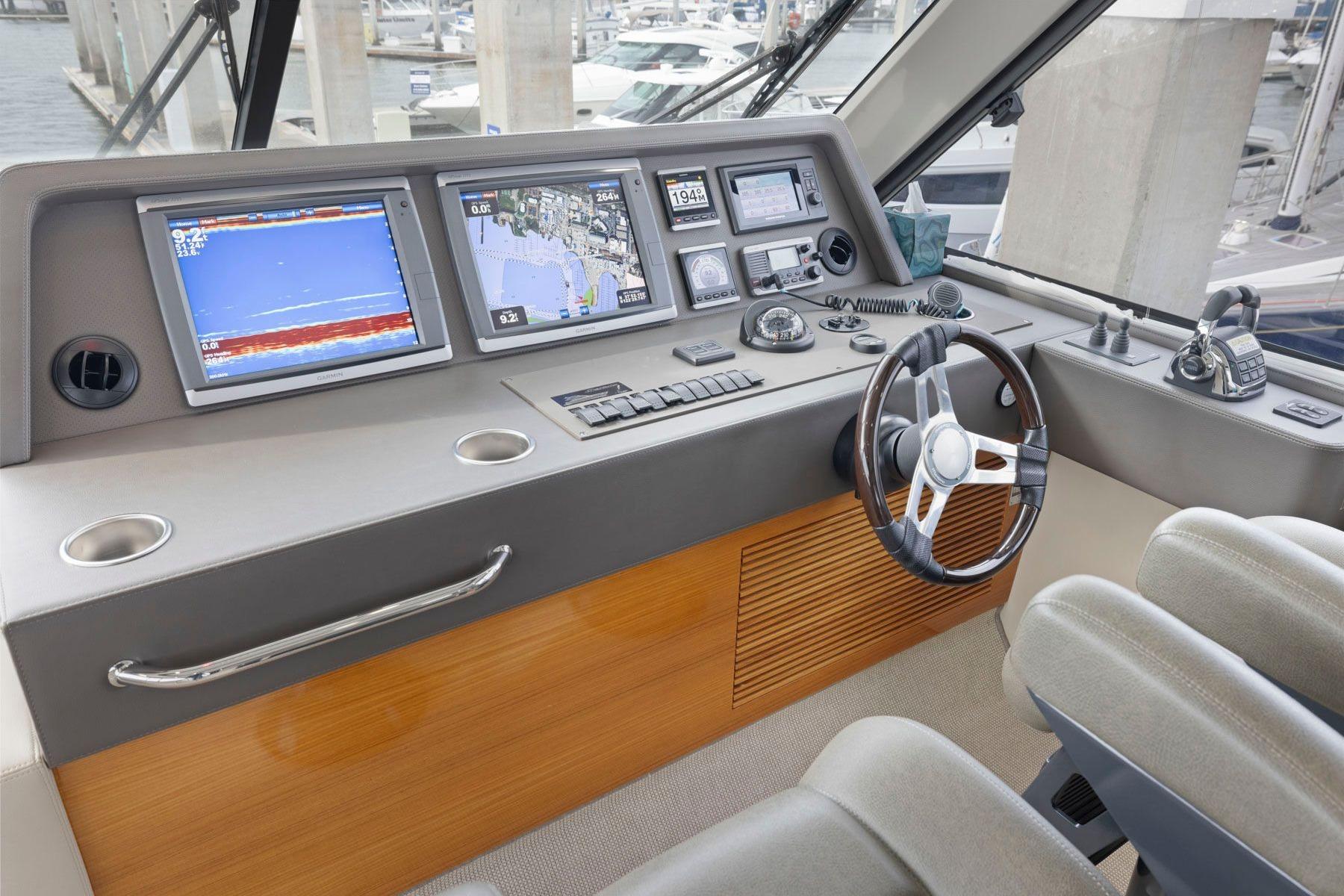Helm of 2014 Maritimo M50 yacht with navigation screens and controls.