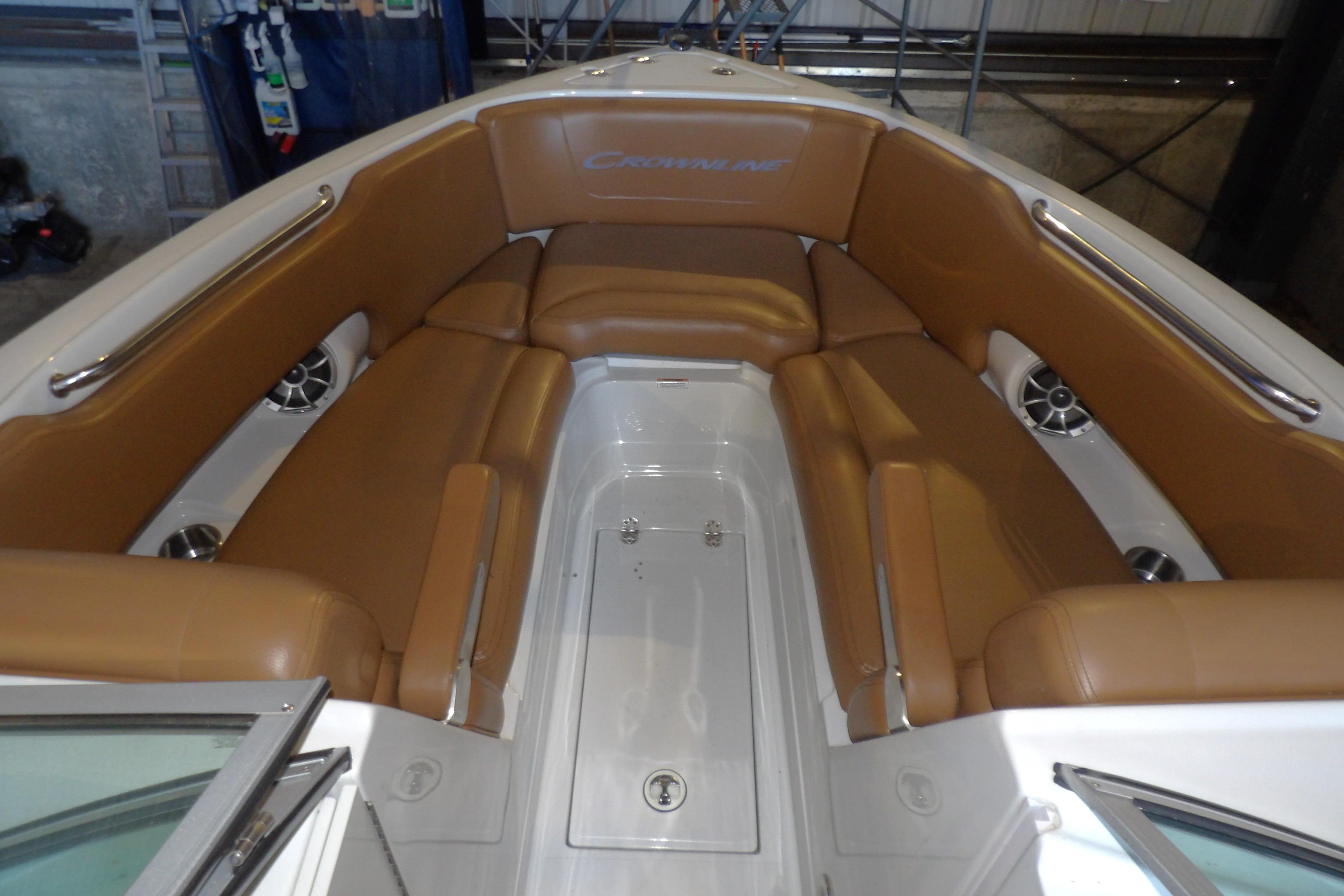 2023 Crownline 250 XSS boat interior with tan seating and stainless steel accents.