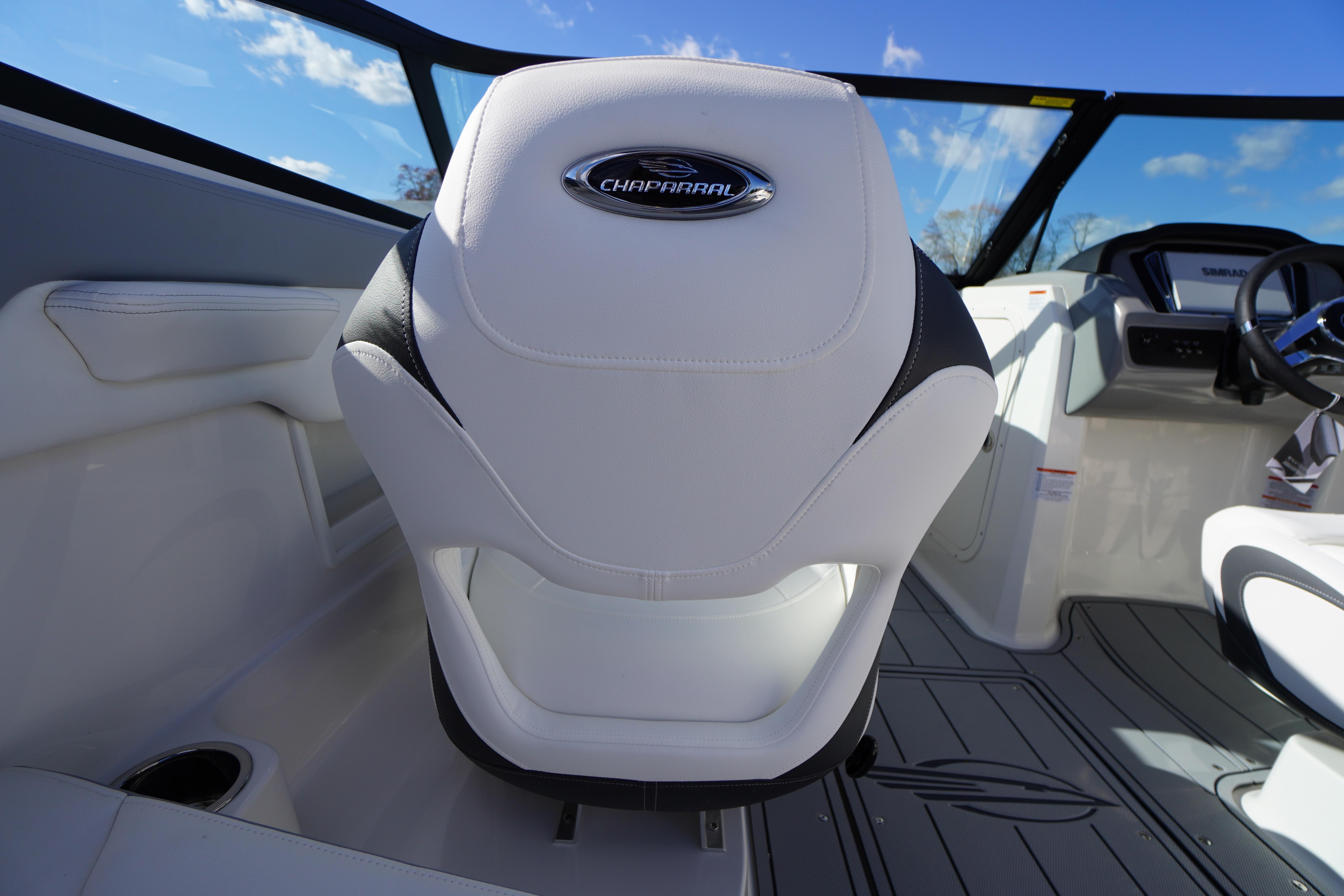 2026 Chaparral 23 SSi OB boat interior with white seating and modern dashboard.