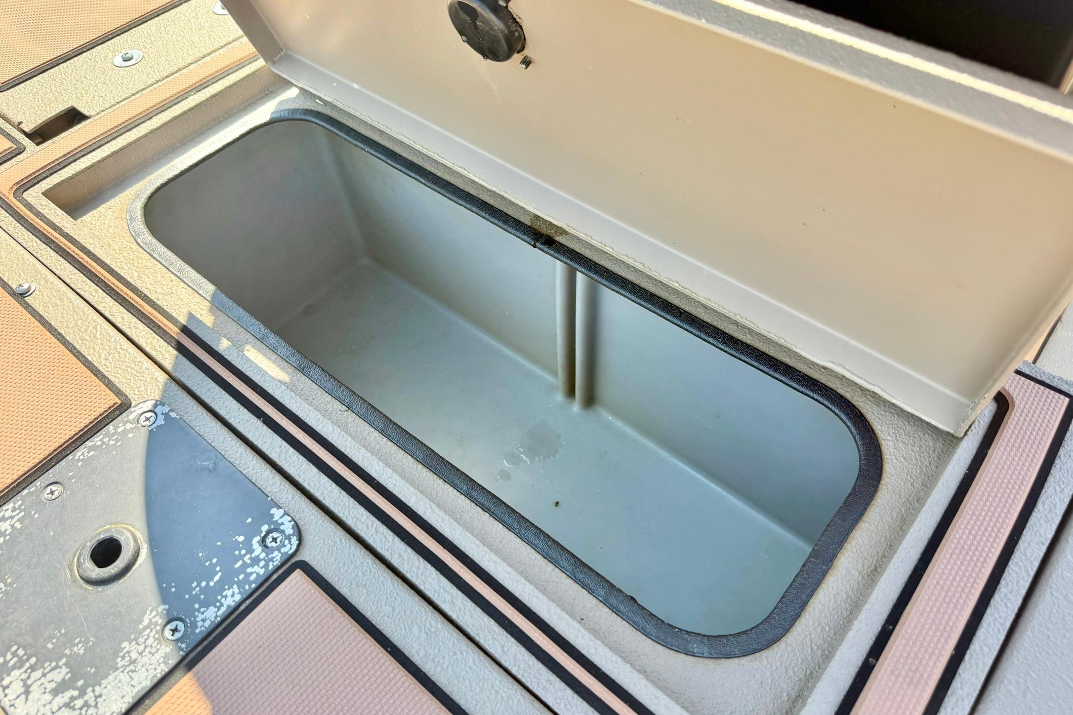 Open storage compartment on a 2019 Excel 230 Bay Pro boat deck.