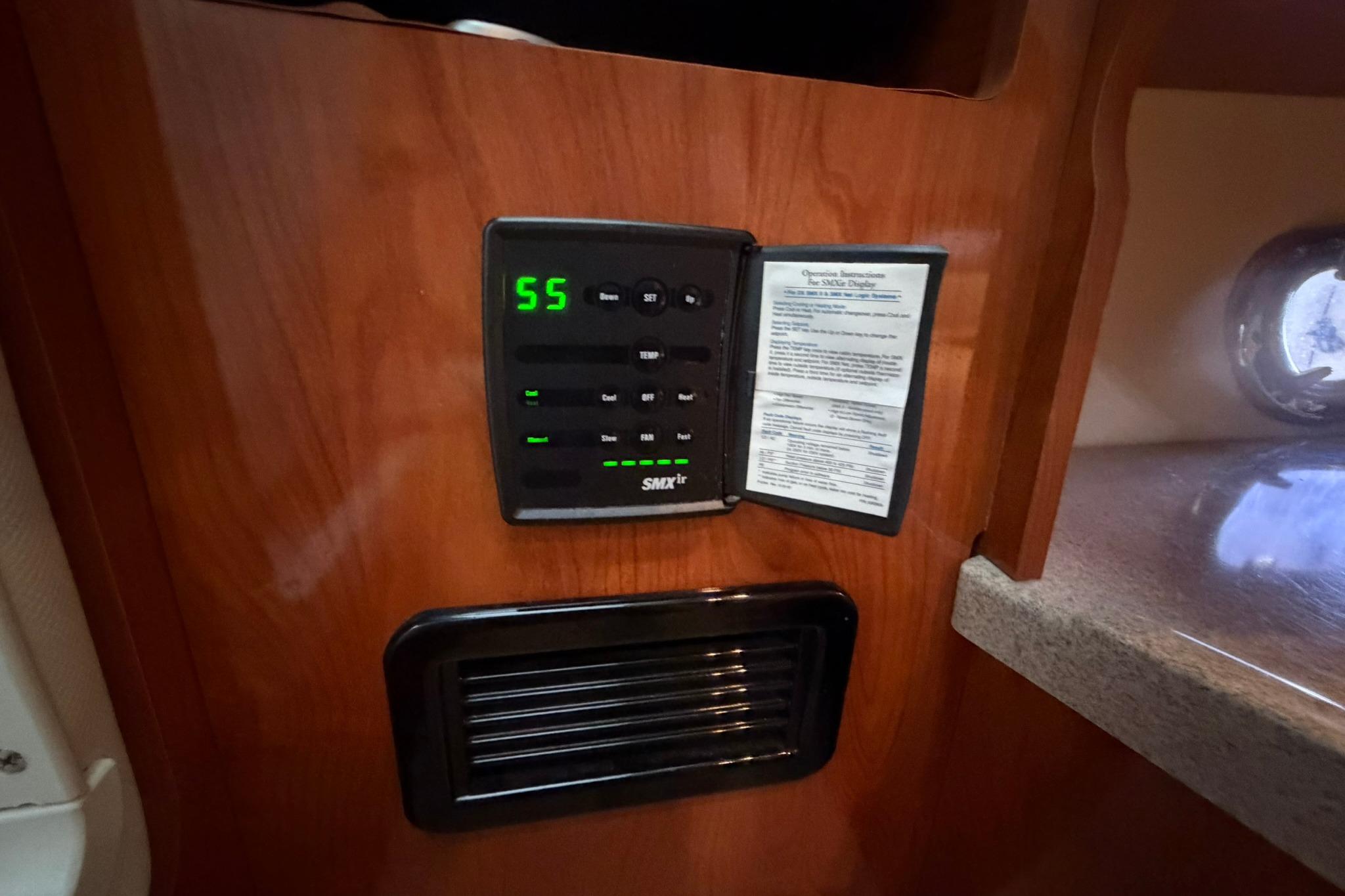2008 Four Winns V248 cabin control panel with digital display and operational instructions.