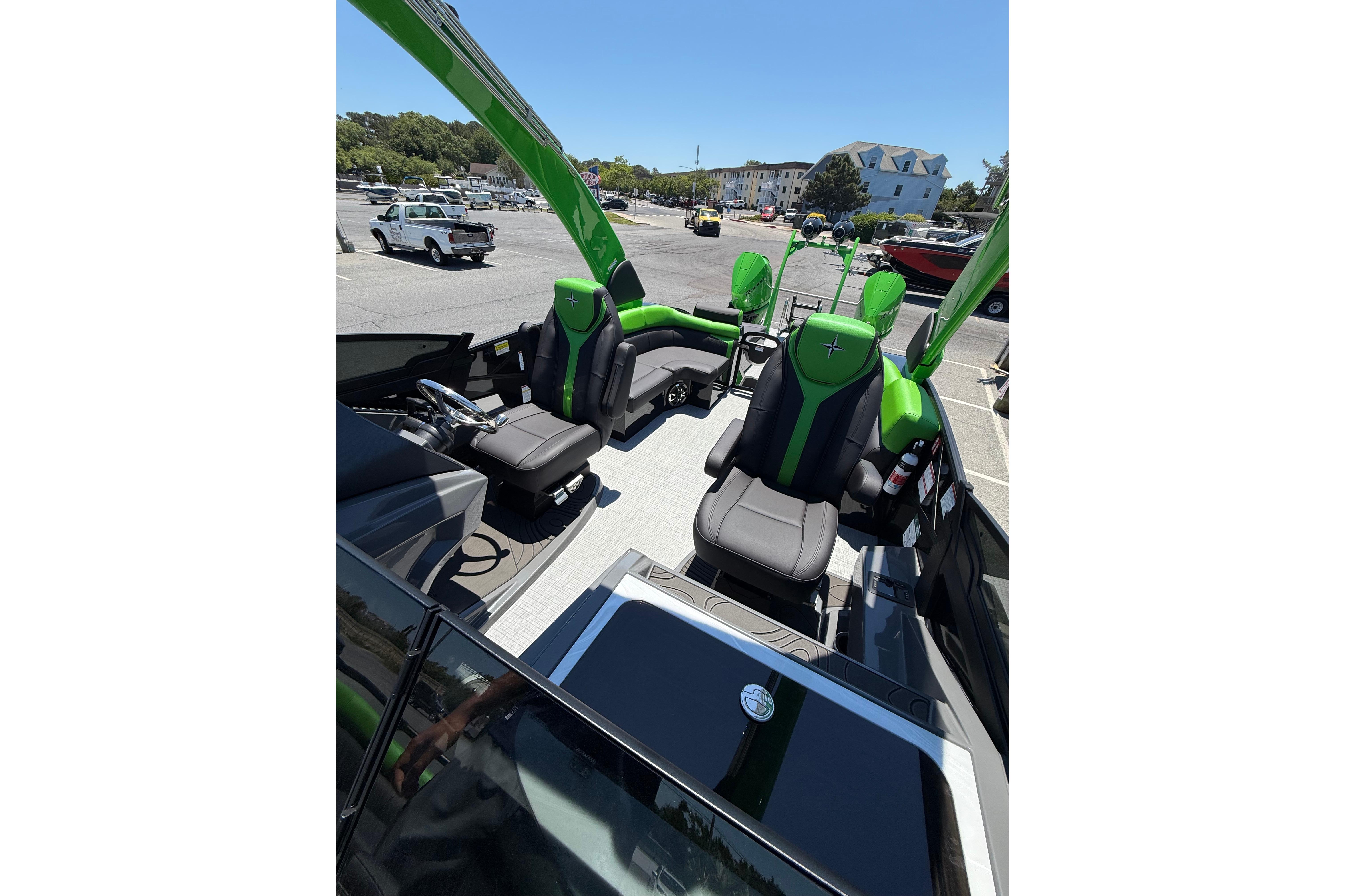 2026 Berkshire Sport SLX9 DC boat interior with green and black seating, parked outdoors.