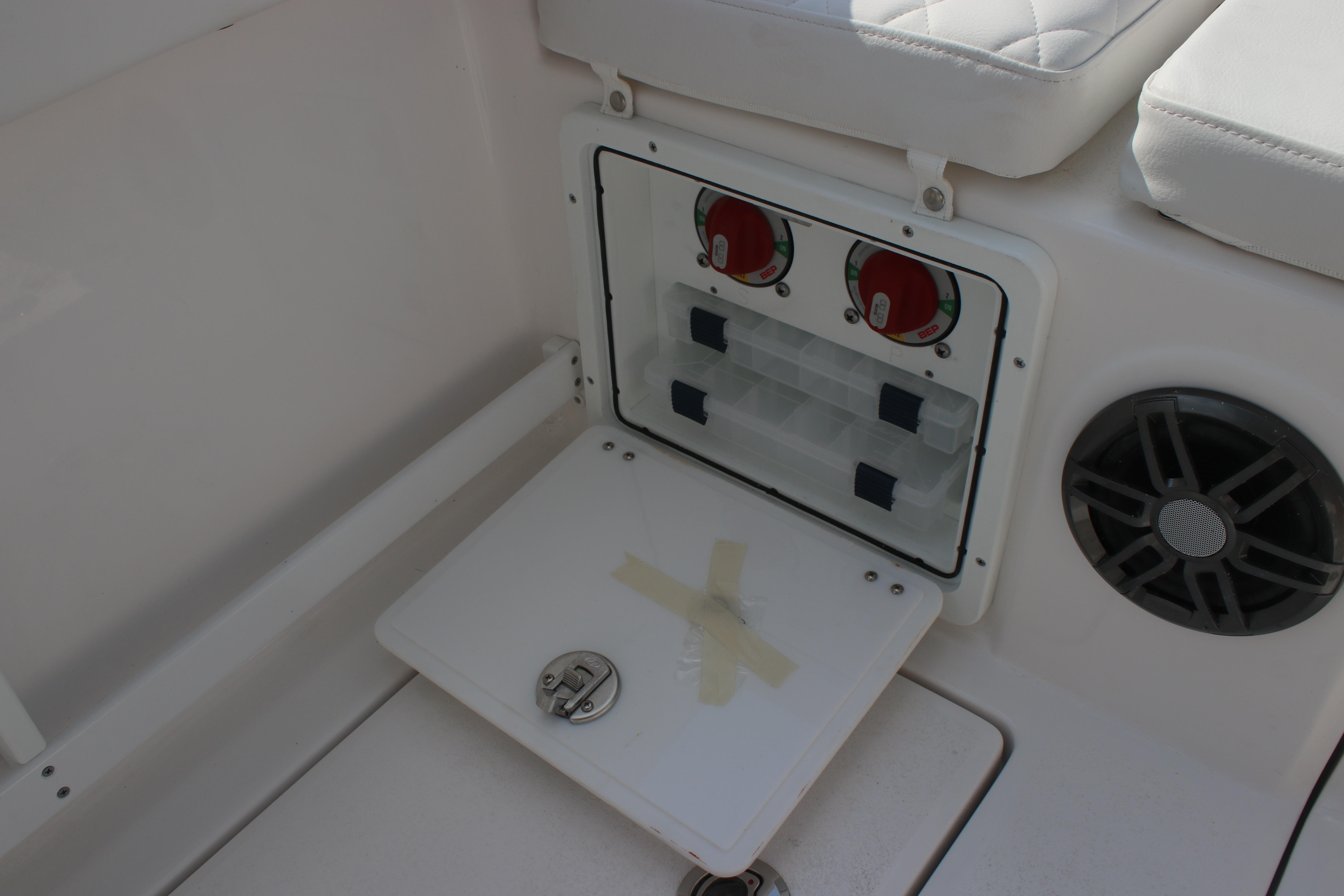 2026 Sea Fox 268 Commander boat storage compartment with control panel and speaker.