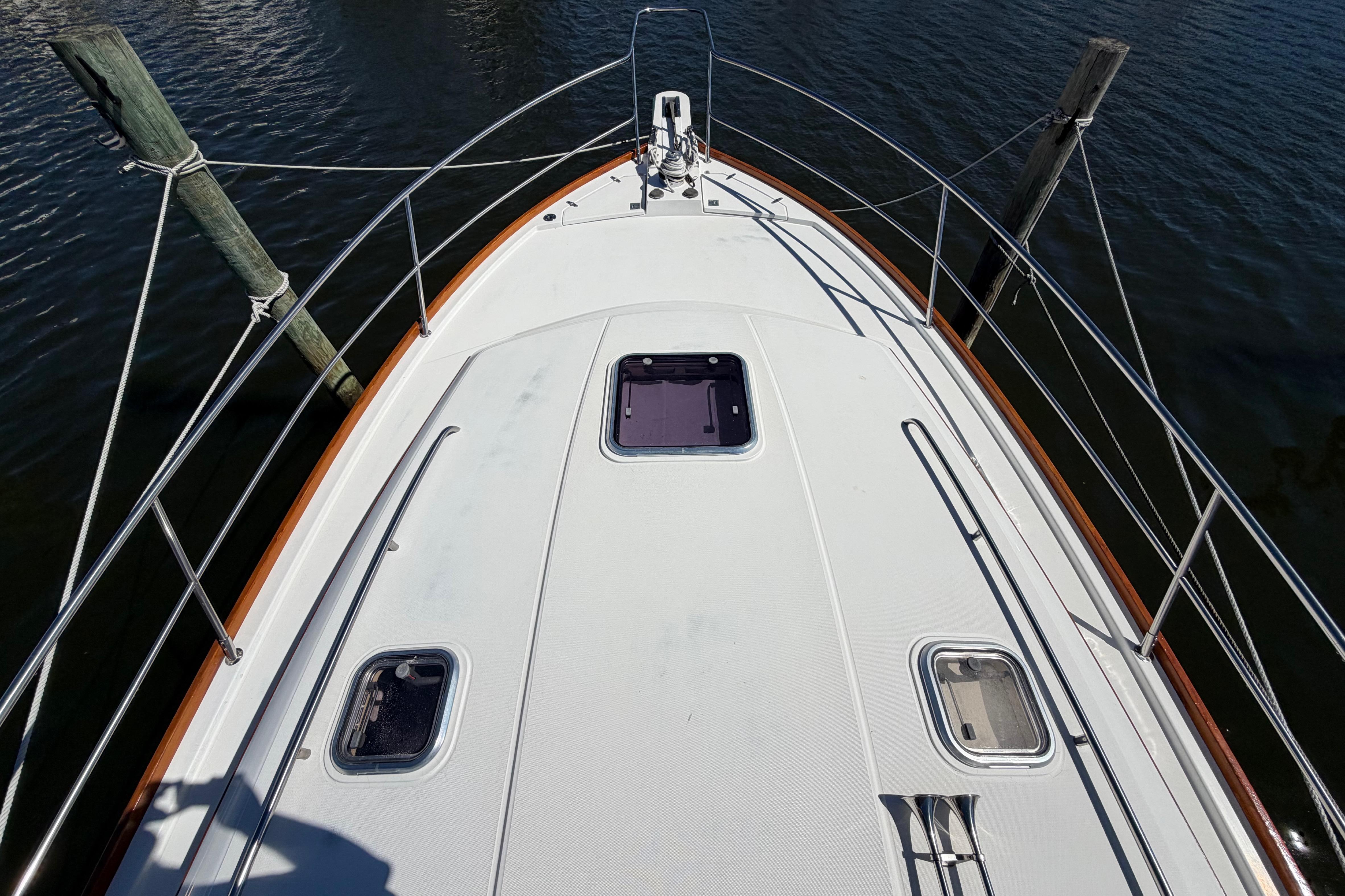 Bow view of 2000 Sabreline 36 Express yacht, docked with visible deck hatches.