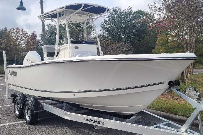 2026 Mako 214 Center Console boat on trailer in parking lot.