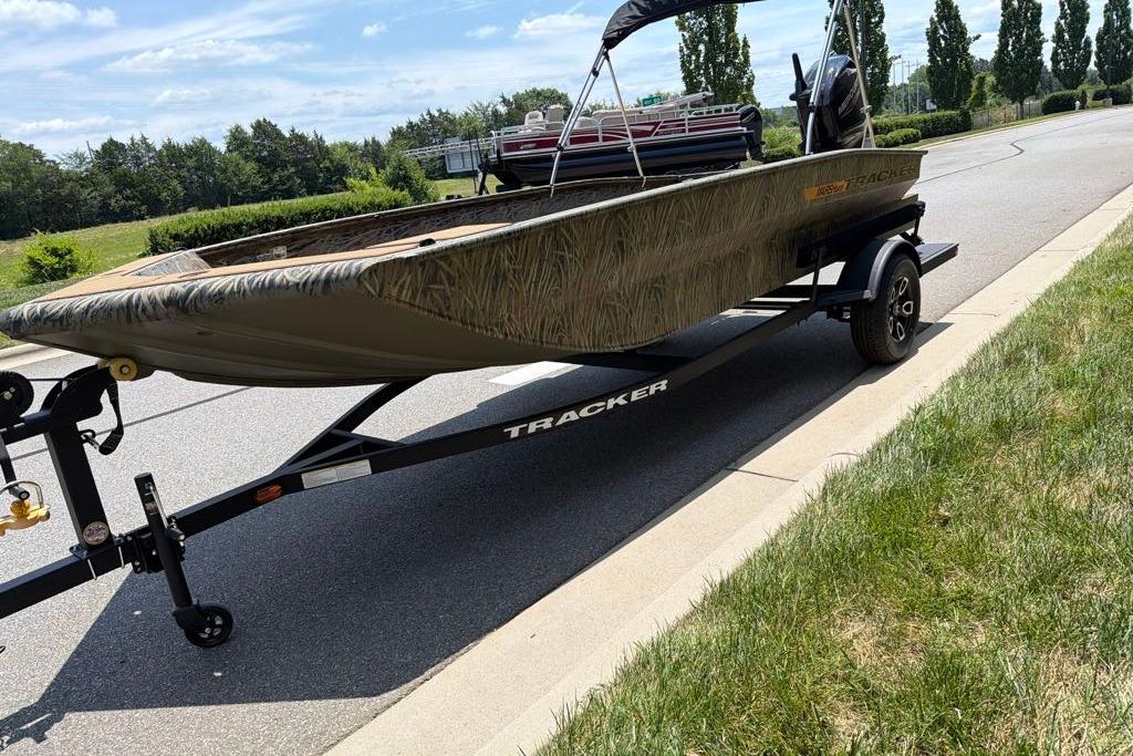 2026 Tracker Grizzly 1756 T Marsh boat on trailer, parked roadside.