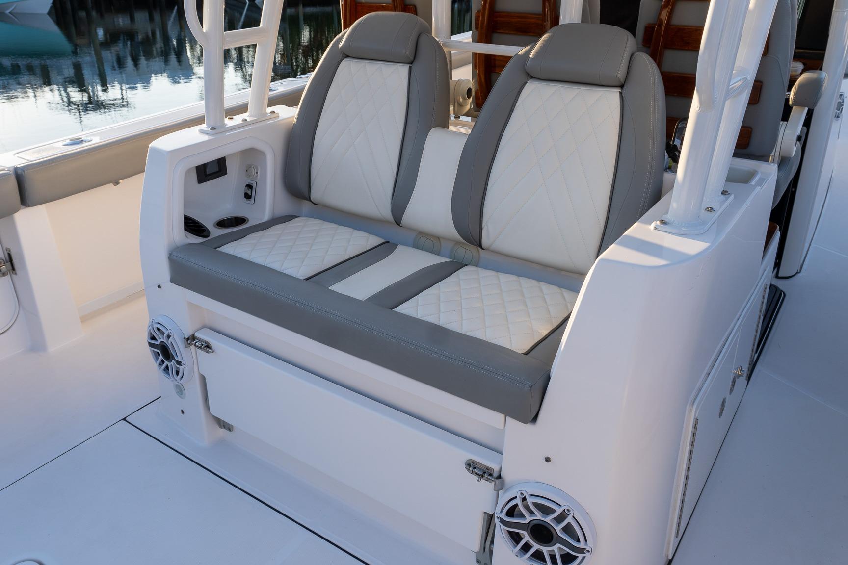 2024 Everglades 395 Center Console boat seating with elegant upholstery and built-in speakers.