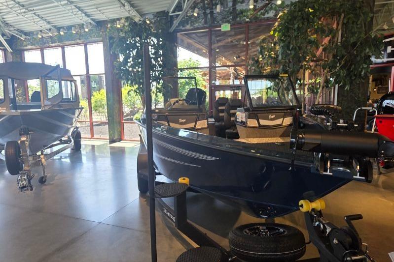 2026 Ranger VX1788 WT boat displayed in a showroom with large windows and greenery.