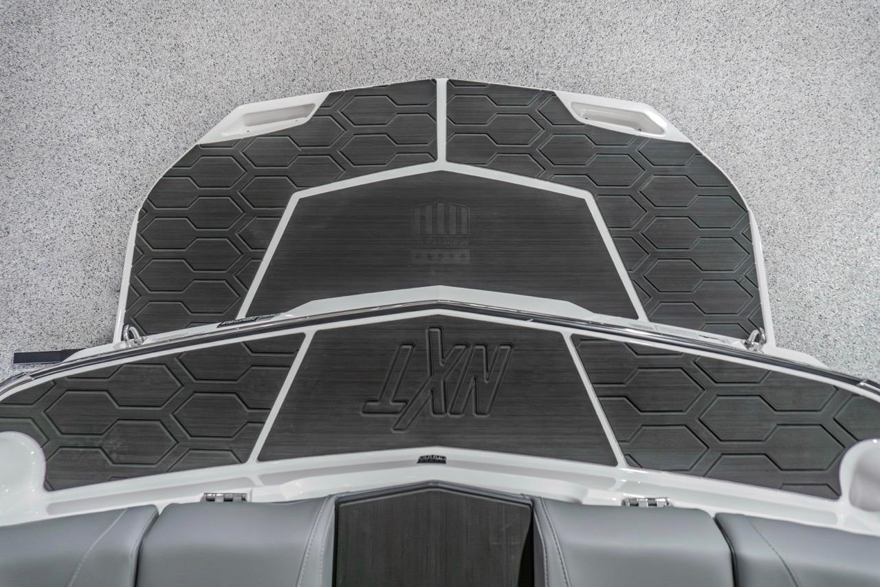 2026 MasterCraft NXT20 boat deck with hexagonal pattern and logo.
