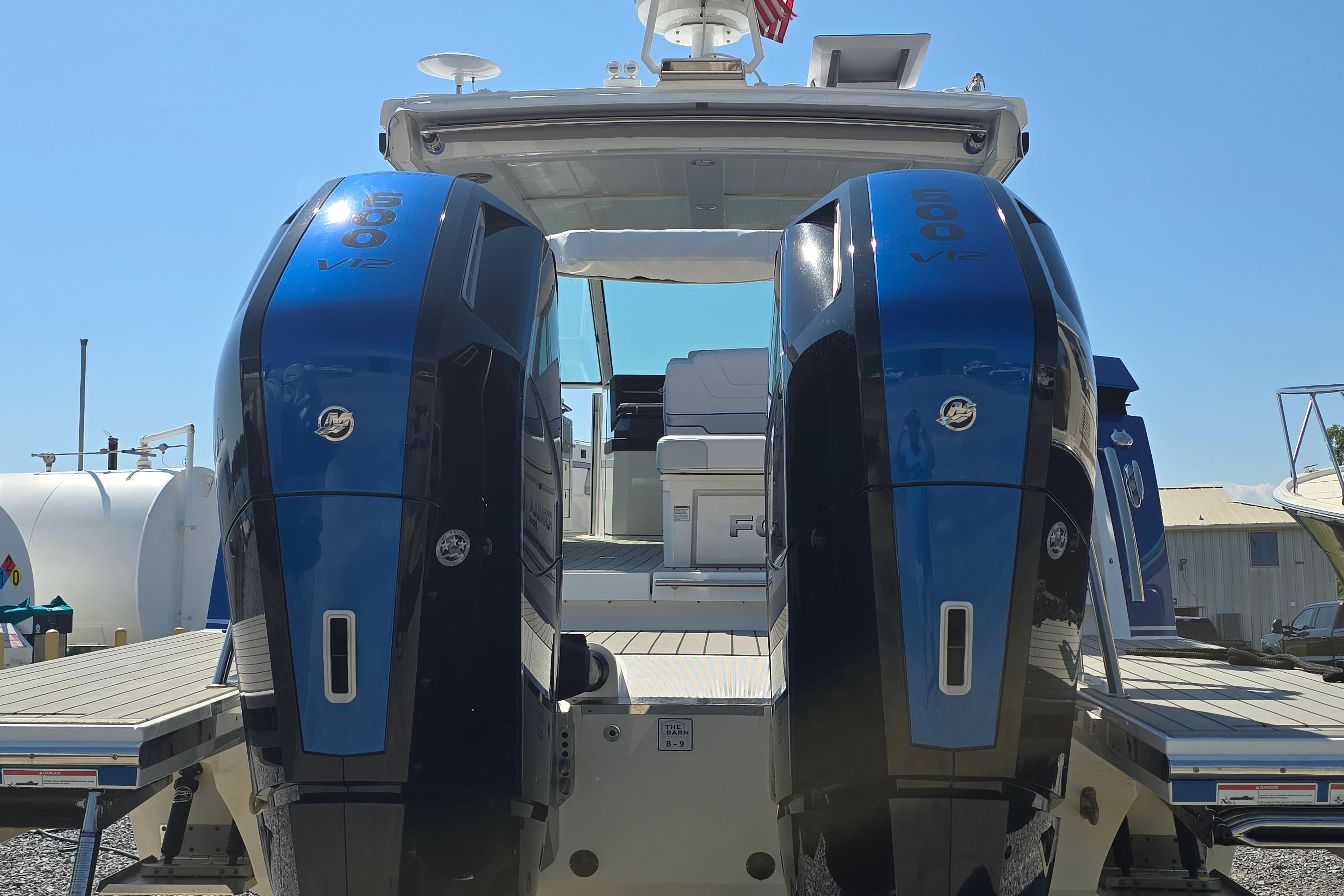 2025 Formula 380 Super Sport Crossover OB with dual outboard engines, docked under clear skies.