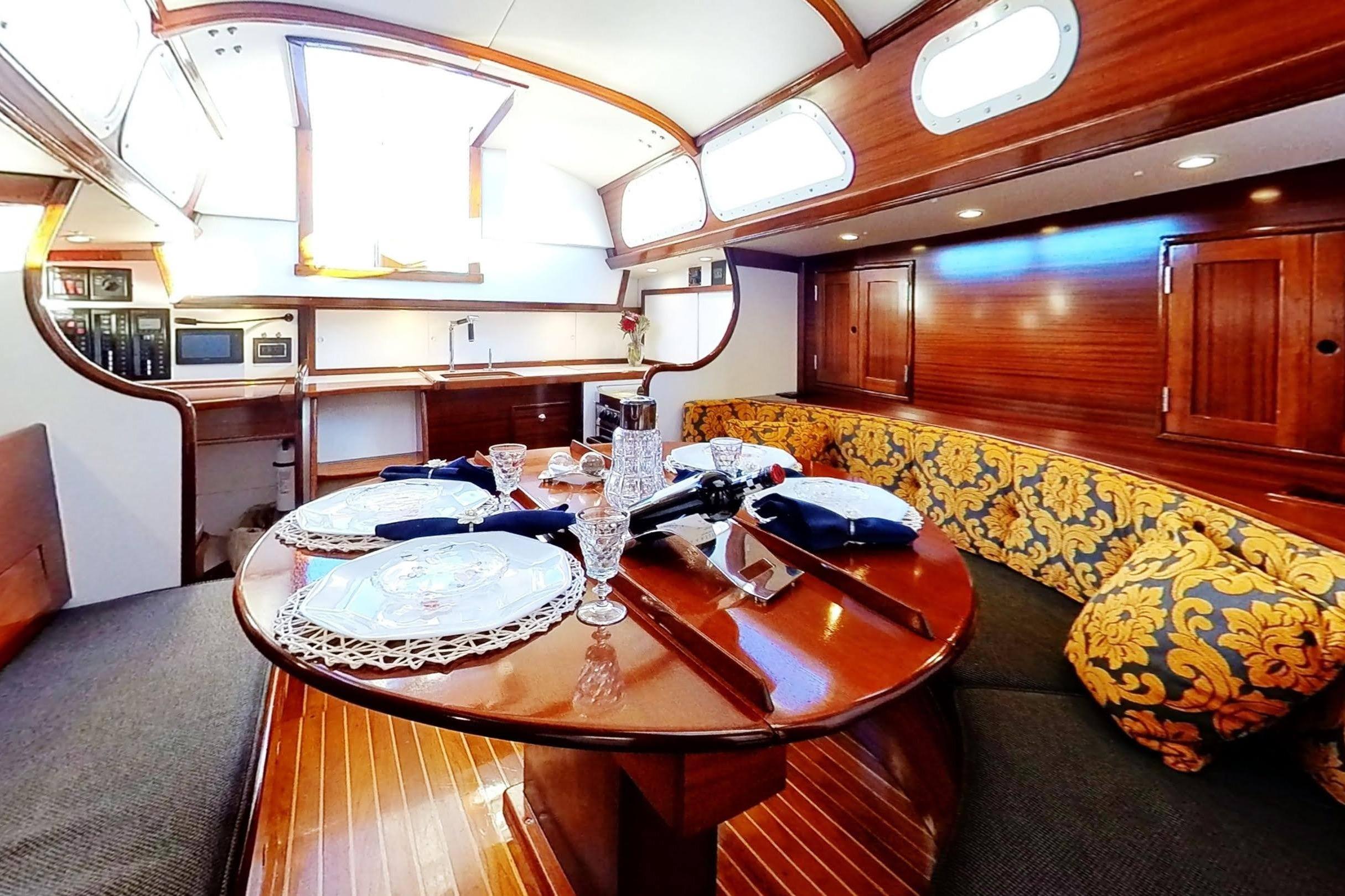 Luxurious interior of a 1970 Hinckley Bermuda 40 yacht with elegant dining setup.