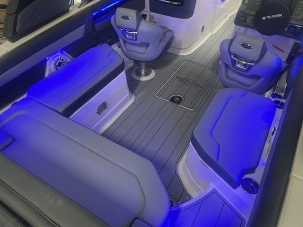 Interior of 2025 Chaparral 267 SSX boat with blue LED lighting and modern seating.
