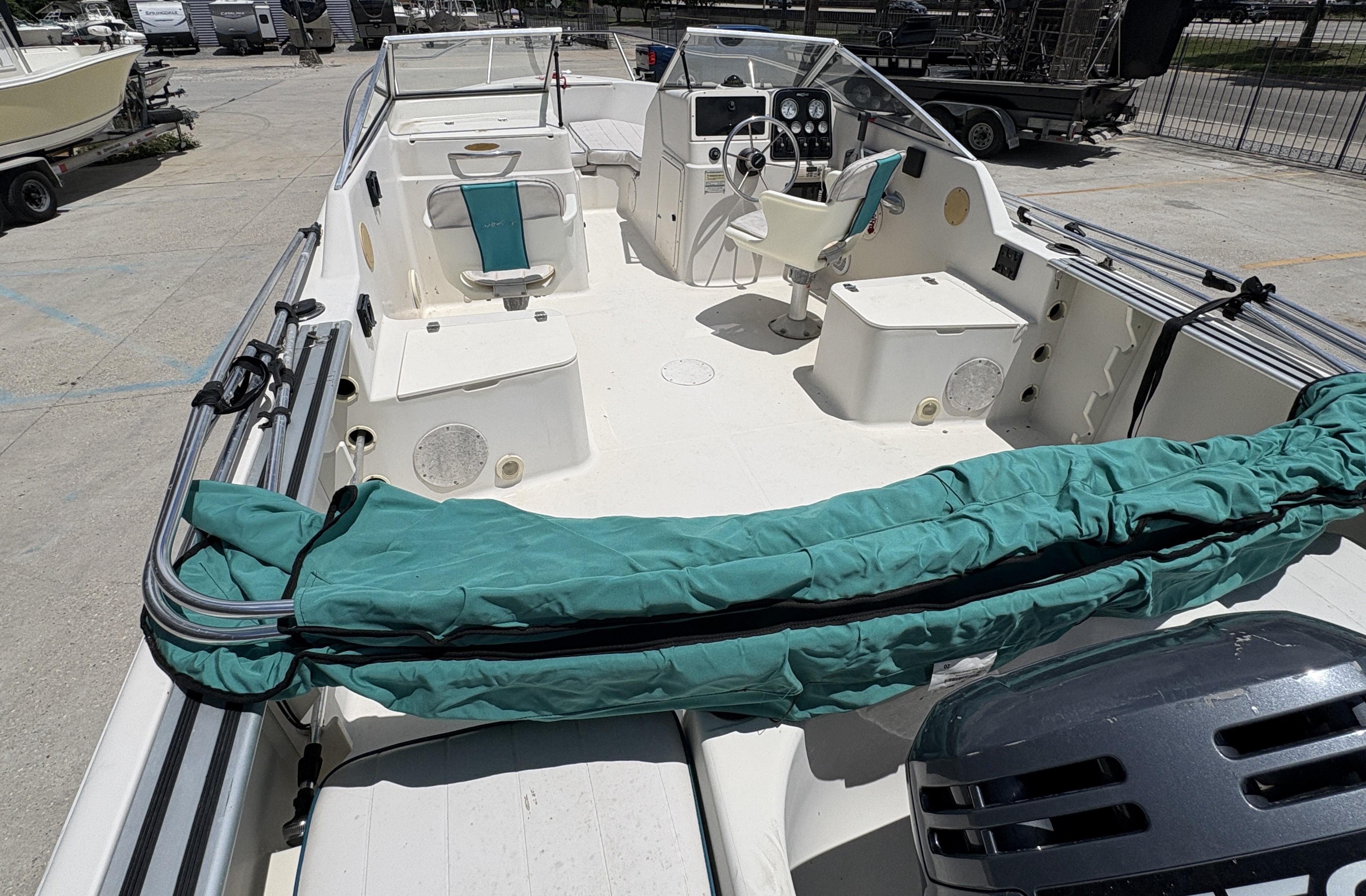 1996 Pro-Line 202 boat interior with seating and steering console, docked outdoors.