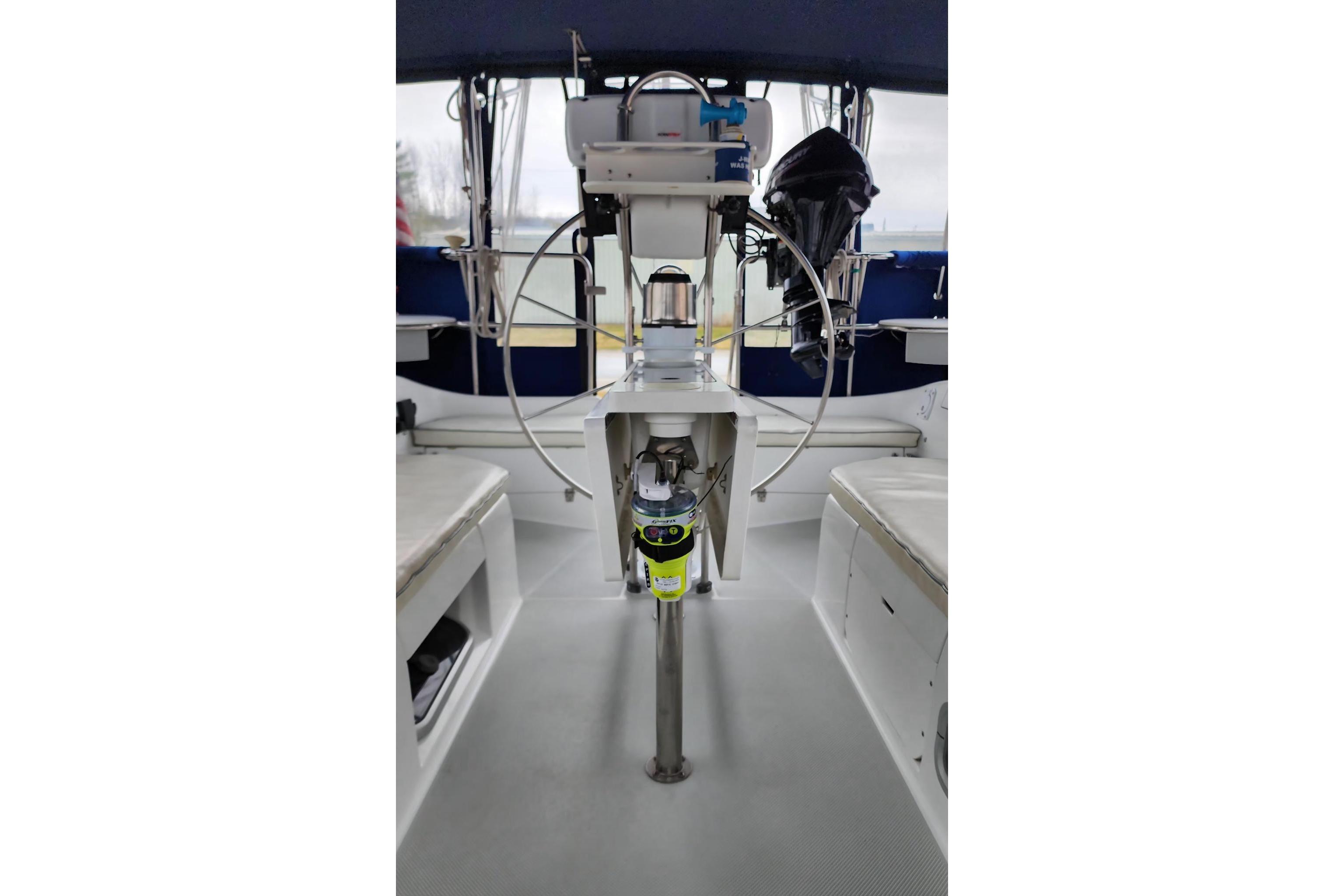 Cockpit of a 1998 Catalina 42 MkII sailboat with steering wheel and seating.