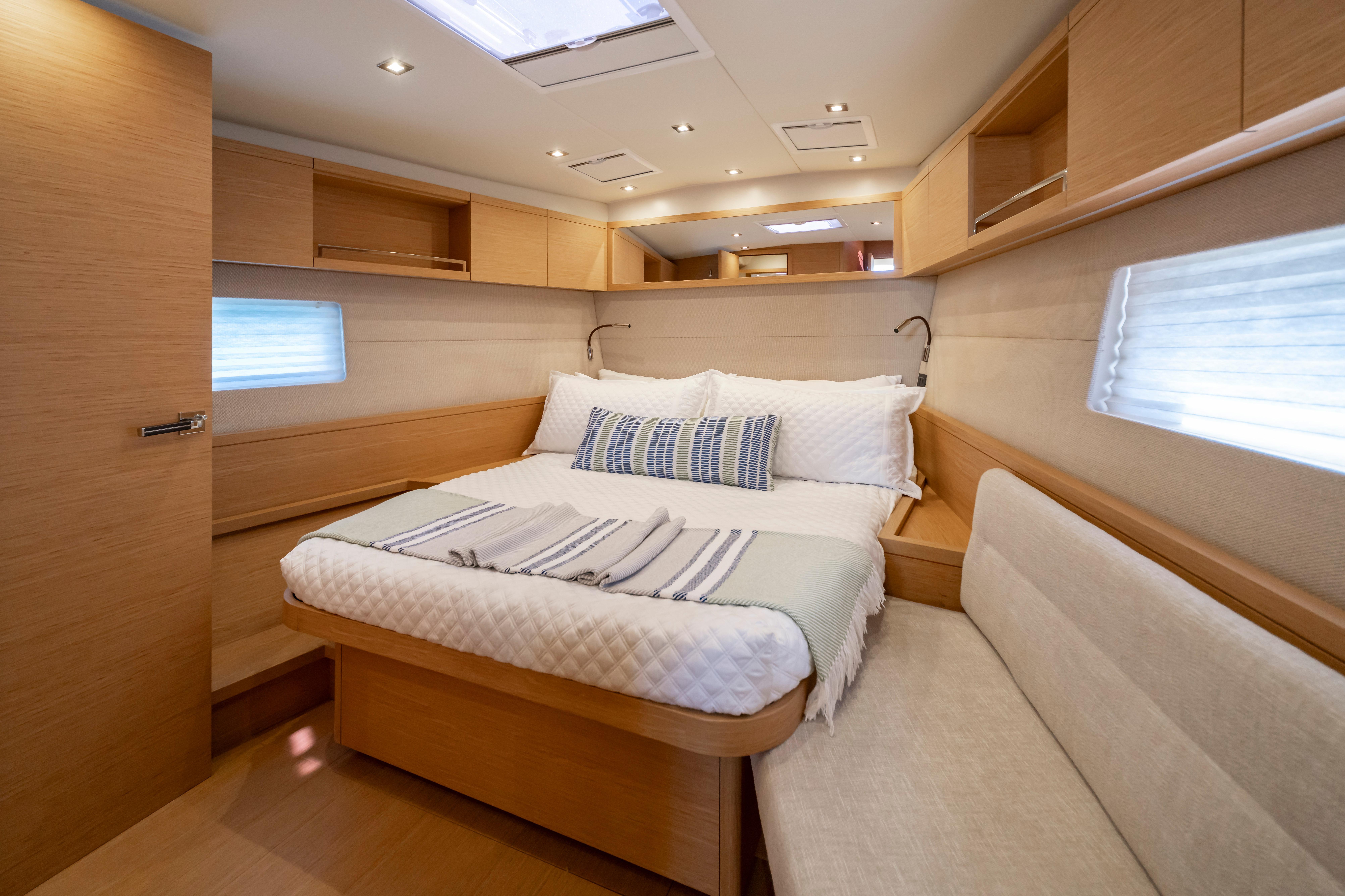 Luxurious interior cabin of 2016 Grand Soleil 58 yacht with cozy bed and modern design.