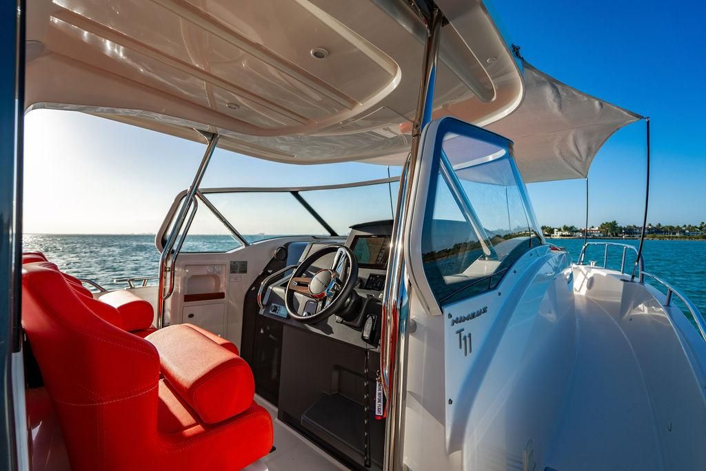 Interior view of Nimbus Tender 11 boat, 2023 model, featuring red seating.