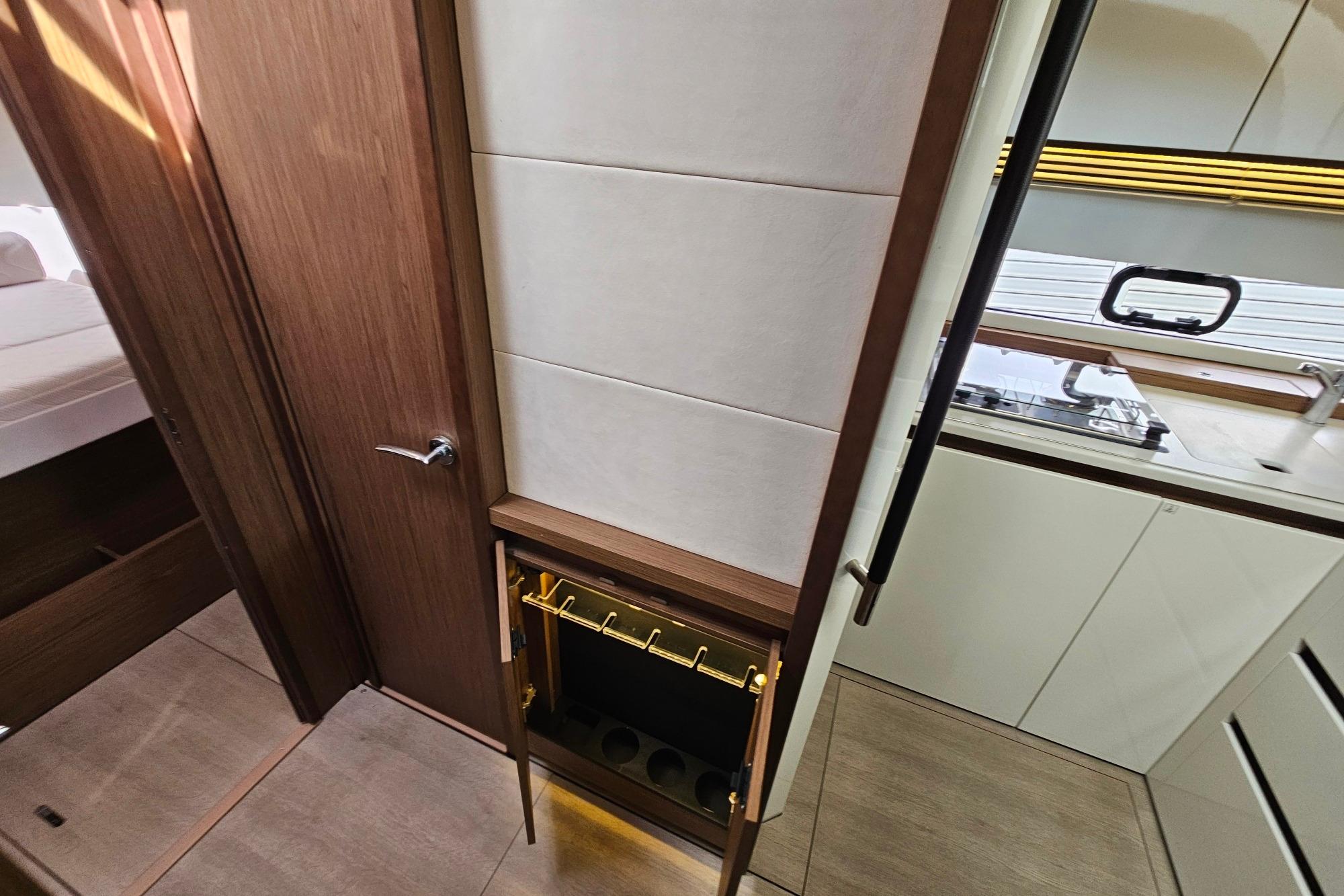 Interior of 2017 Jeanneau Leader 40 yacht, featuring wood paneling and modern kitchen.