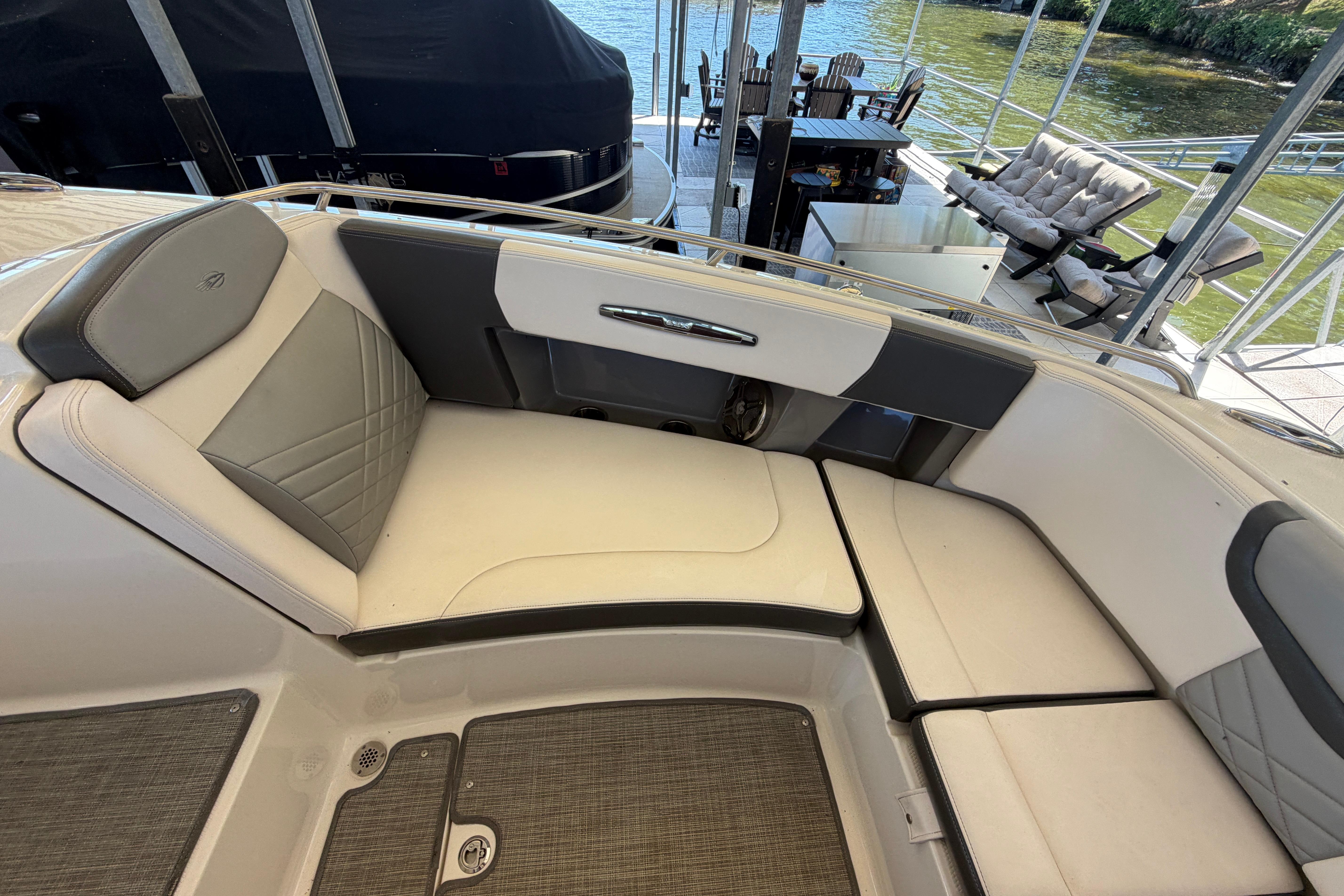 2018 Chaparral 347 SSX boat interior with cushioned seating and lake view.