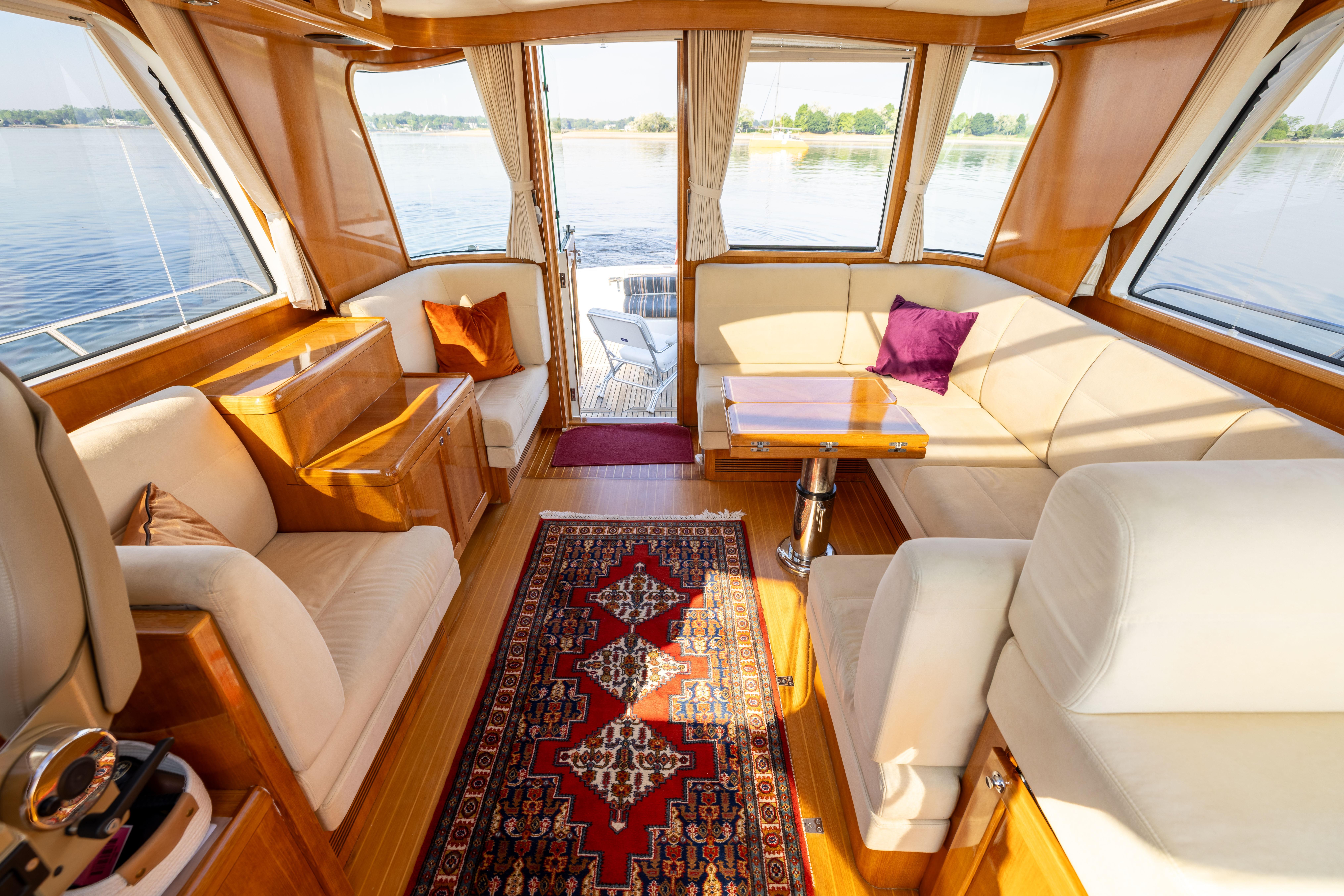 Luxurious interior of 2008 Grand Banks 45 Eastbay SX yacht with elegant seating and scenic views.