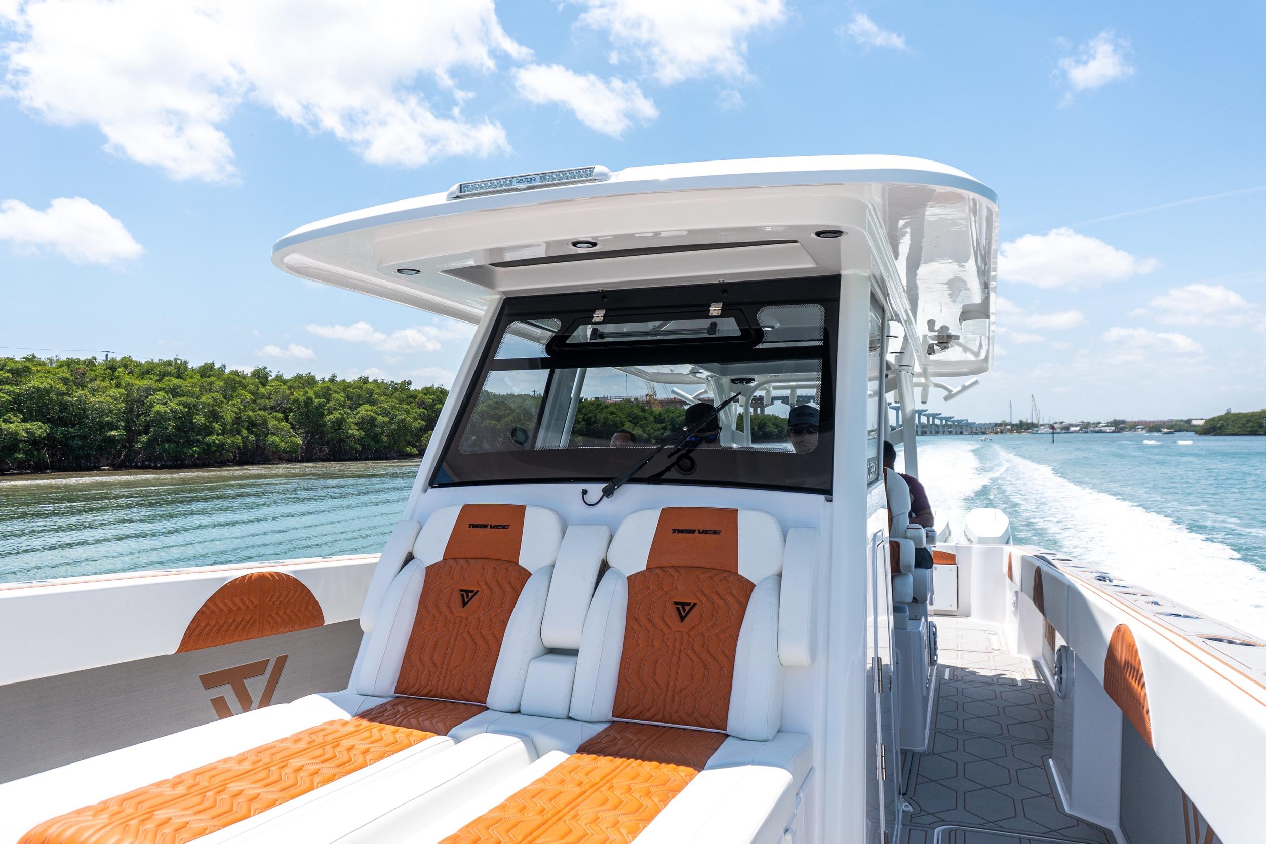 2026 Twin Vee 400 GFX2 CC boat cruising on a sunny day, featuring luxurious seating.