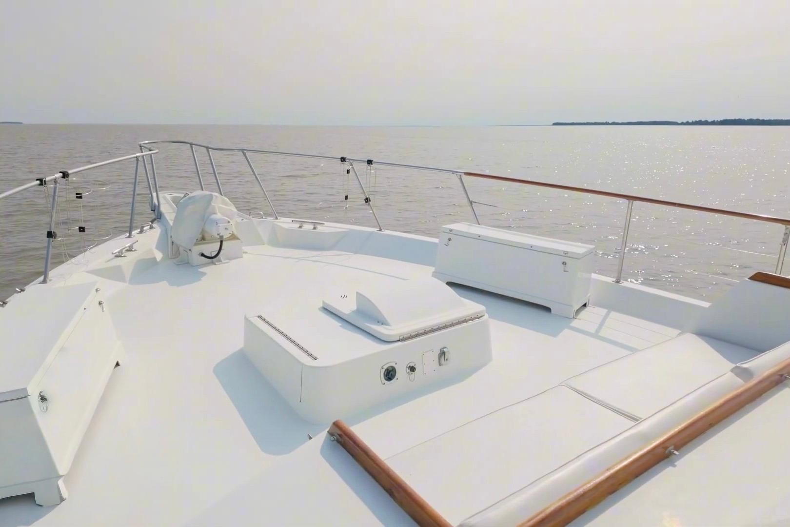 Bow view of 1980 Hatteras 70 Motor Yacht on calm waters.