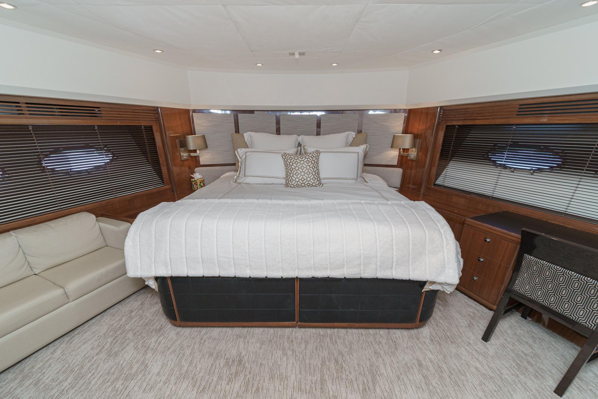 Luxurious bedroom interior of 2011 Princess 95 Motor Yacht with elegant furnishings.