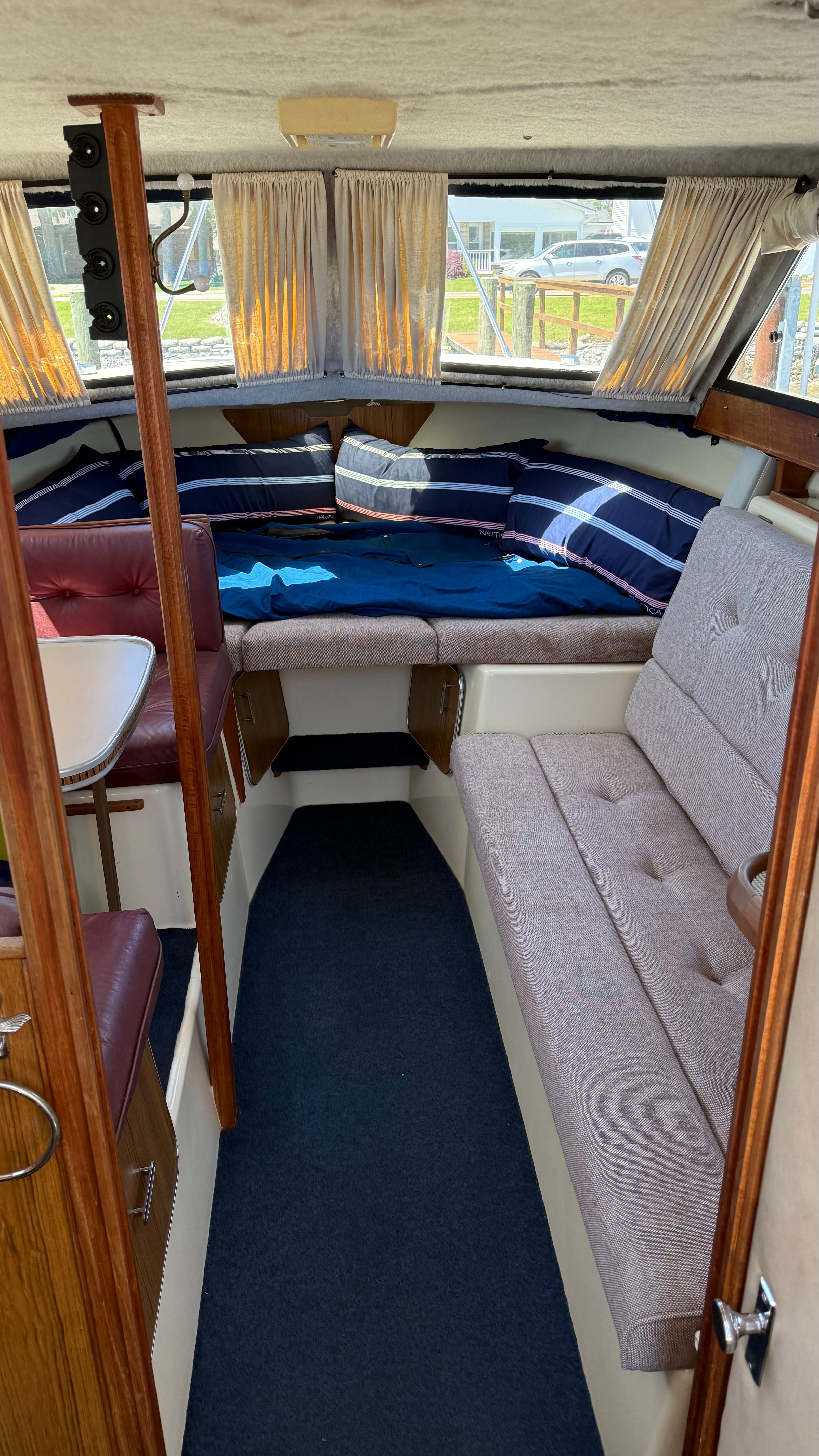 Interior of a Chris-Craft 292 Catalina Sunbridge with seating area and sleeping space.