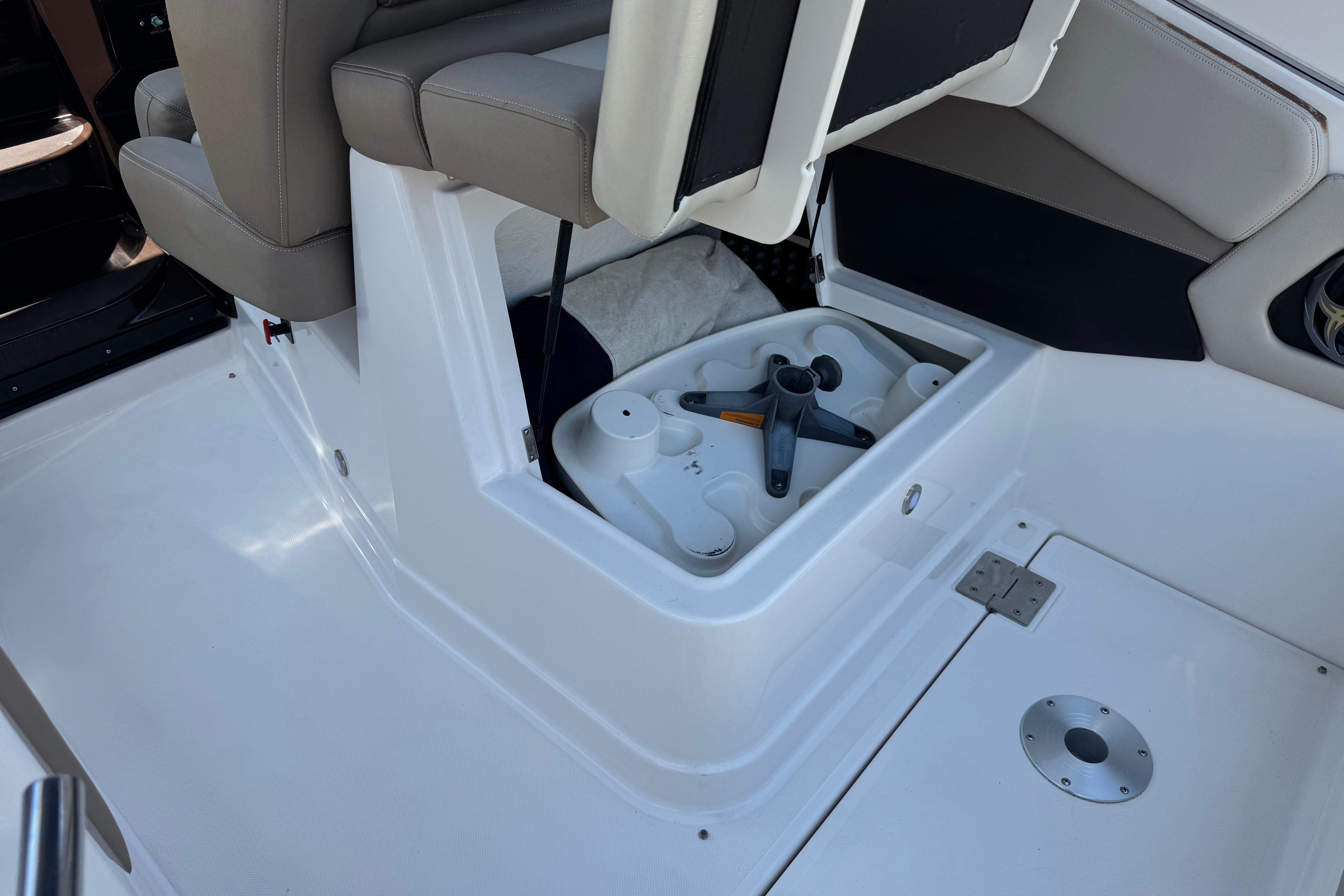 2013 Regal 28 Express boat interior with open storage compartment under seat.