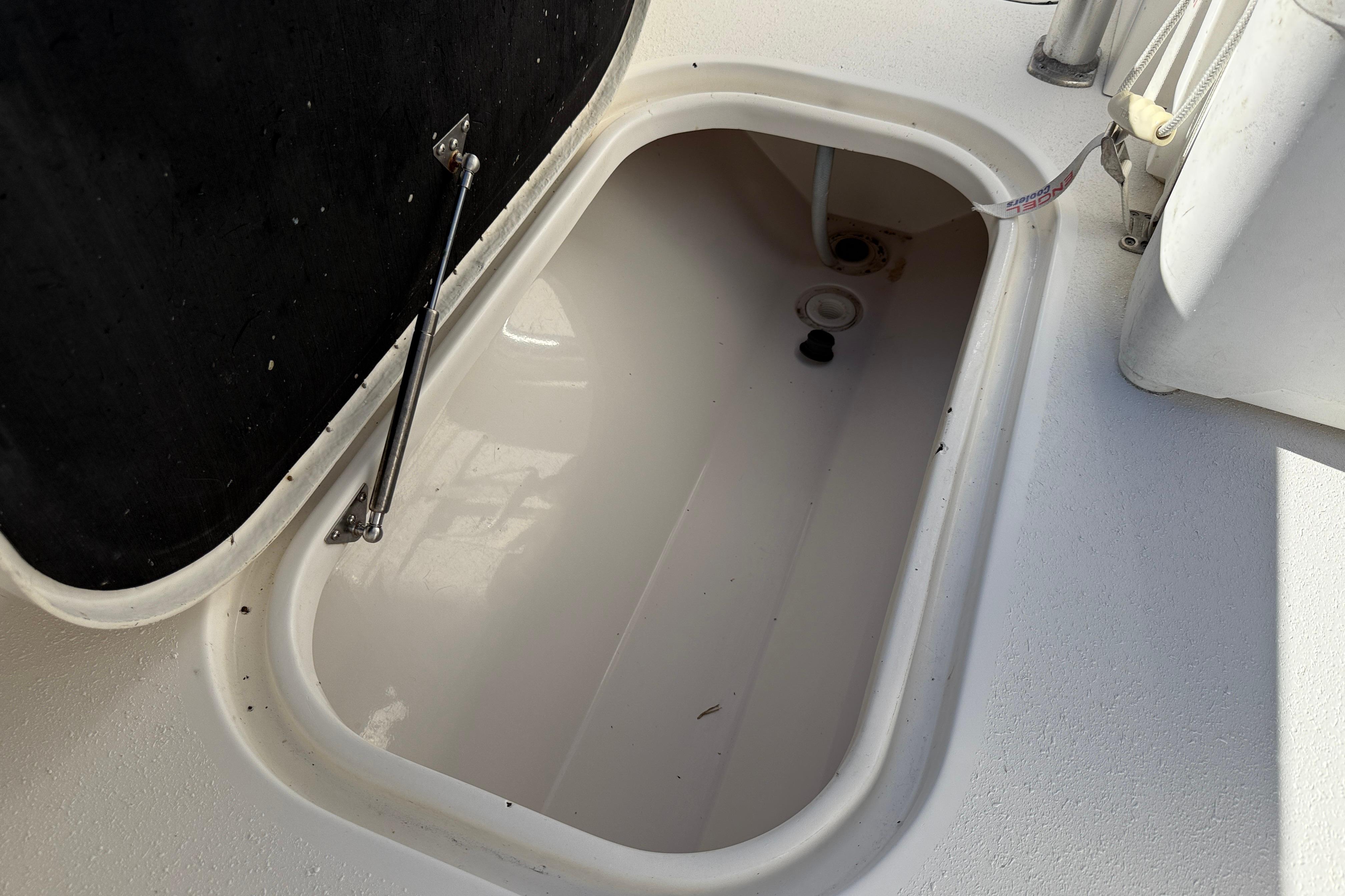 Open storage compartment on 2020 Tideline 235 Hybrid boat.